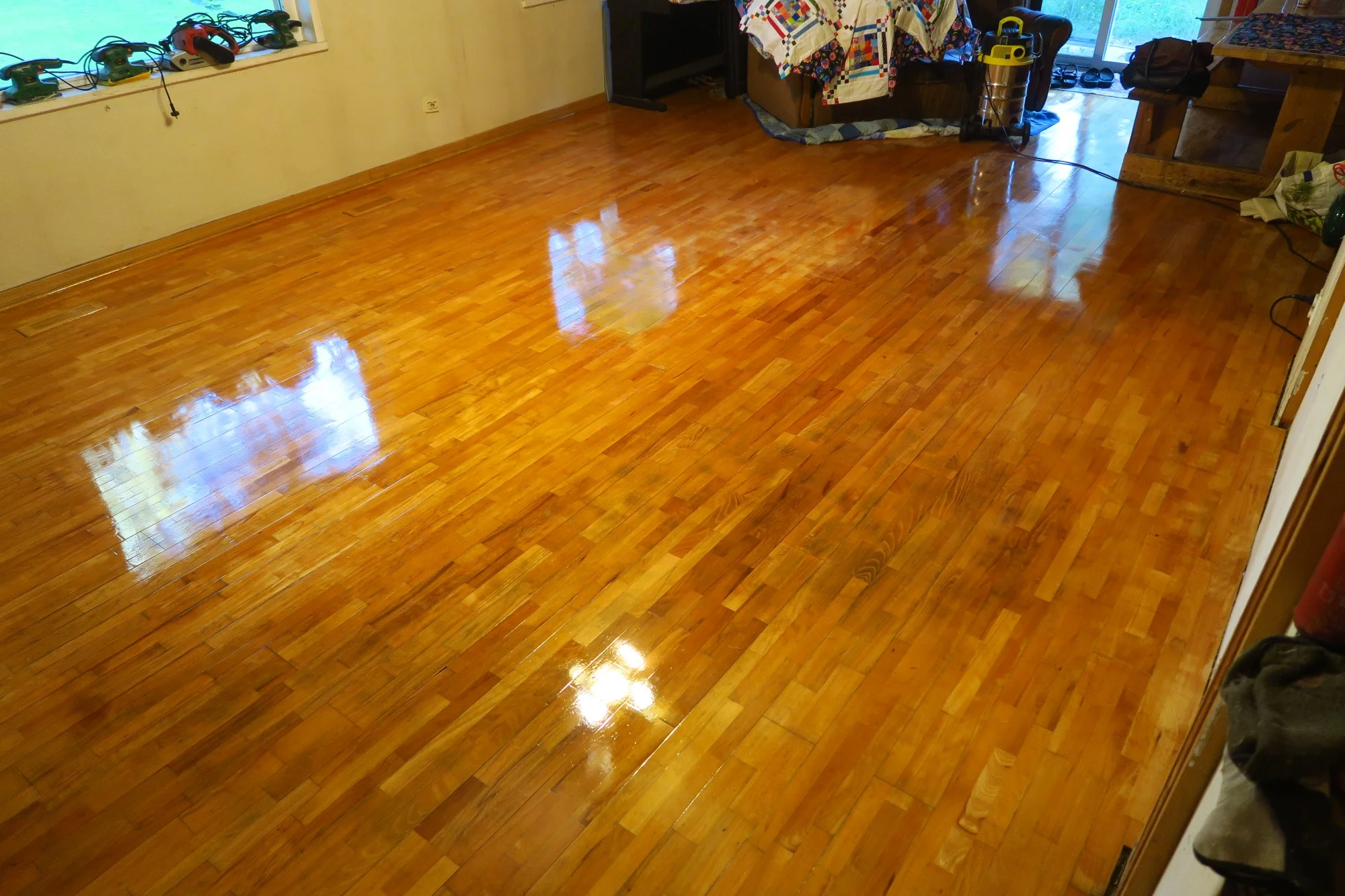 :Looking in the whole area which is our living room/dining room. There’s a sneak peek of a quilt top draped over there some of the furniture way down there.