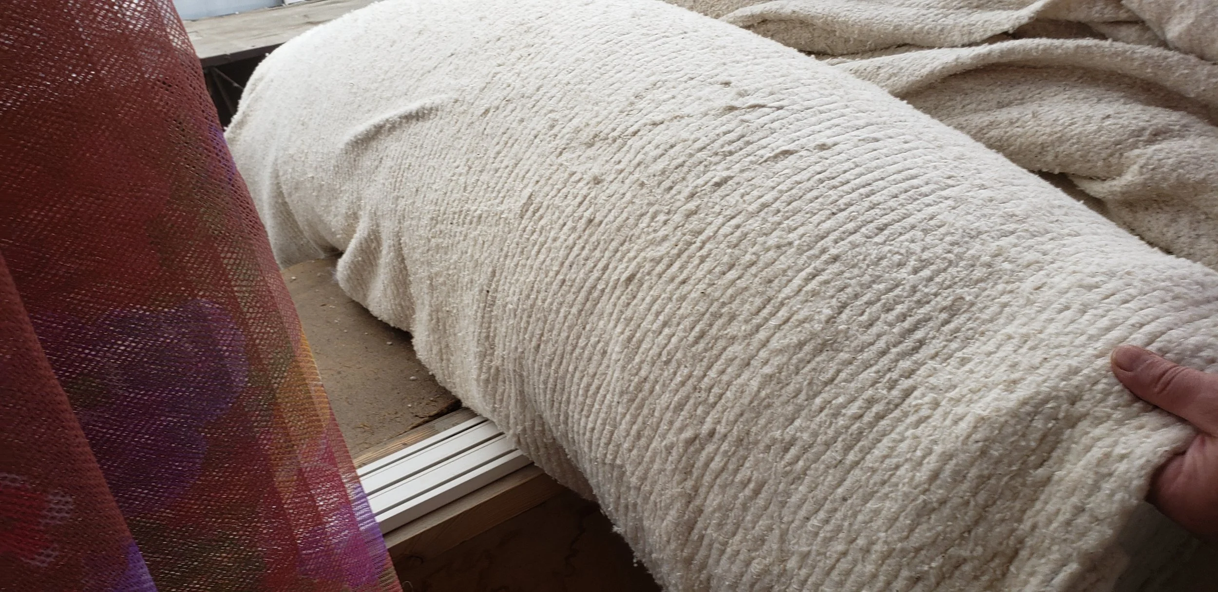 They had two thicknesses of batting - this one is the thicker - about half an inch thick of cotton. Not sure I could actually quilt that. But I had to feel it! Next to the one I’m touching is the thinner batting on a roll.