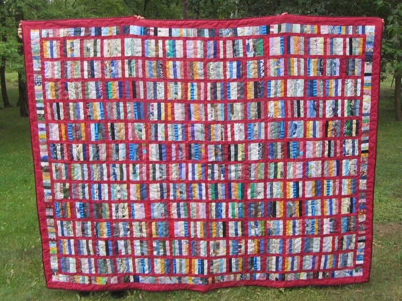 red border strips scrappy quilt.JPG