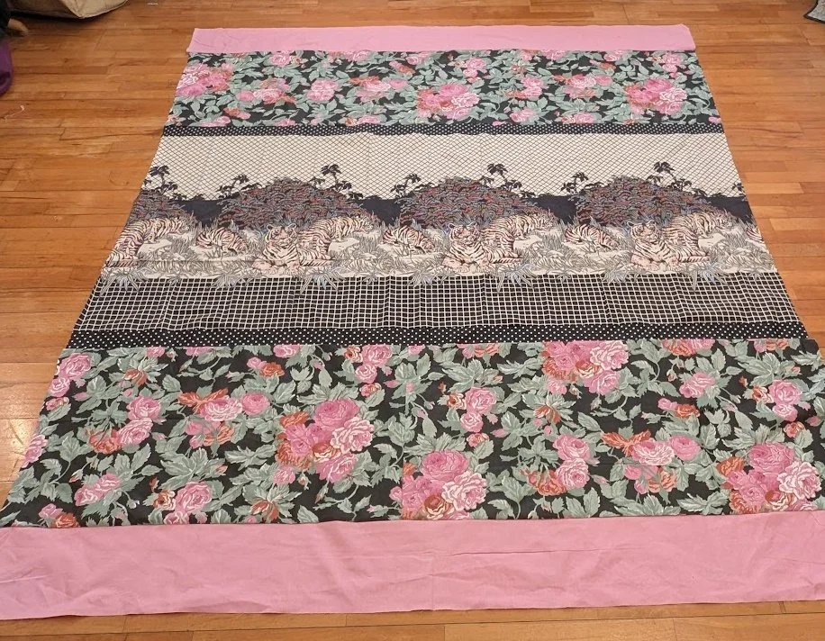 I found a piece of fabric tagged 28" wide by 72" long - it was the tigers. I loved it so I added borders in similar colors and called it a top