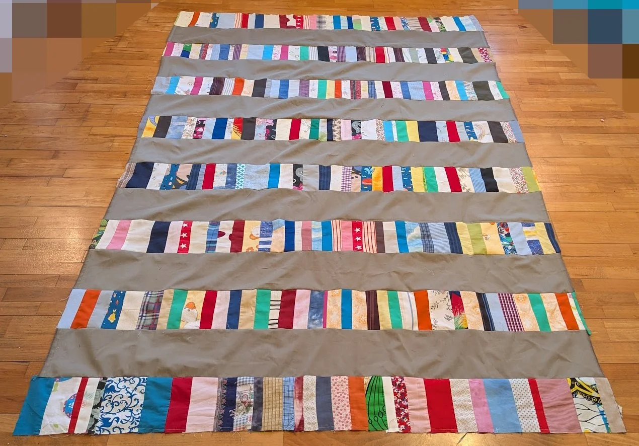 The strips came in a bag from Ewa and her mom and I cut the wide 6.5" strips from menswear and sewed them together.