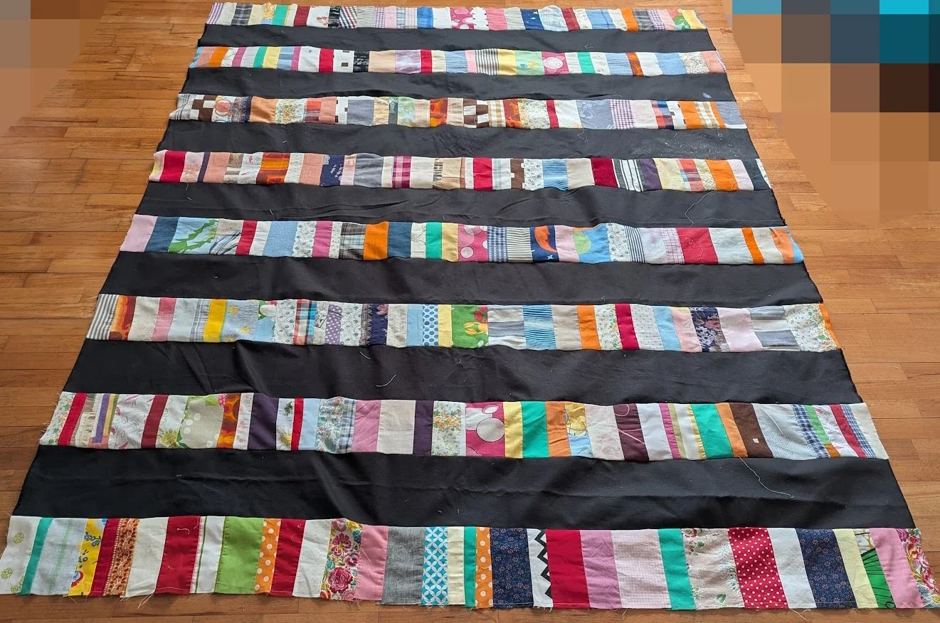 I used strips that Ewa's mom made which were rolled up and cut 6.5" strips x WOF from menswear I have and sewed them together to make this top.