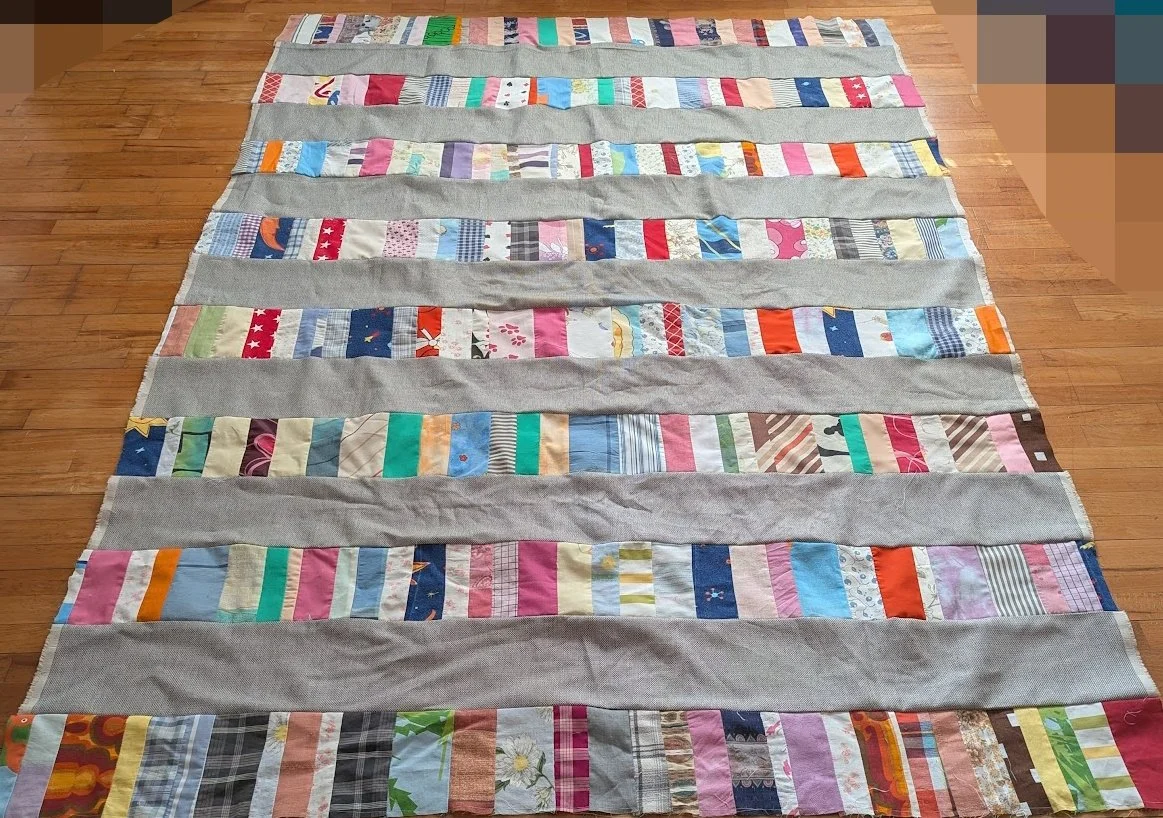 I used strips that Ewa's mom made which were rolled up and cut 6.5" strips x WOF from menswear I have and sewed them together to make this top.