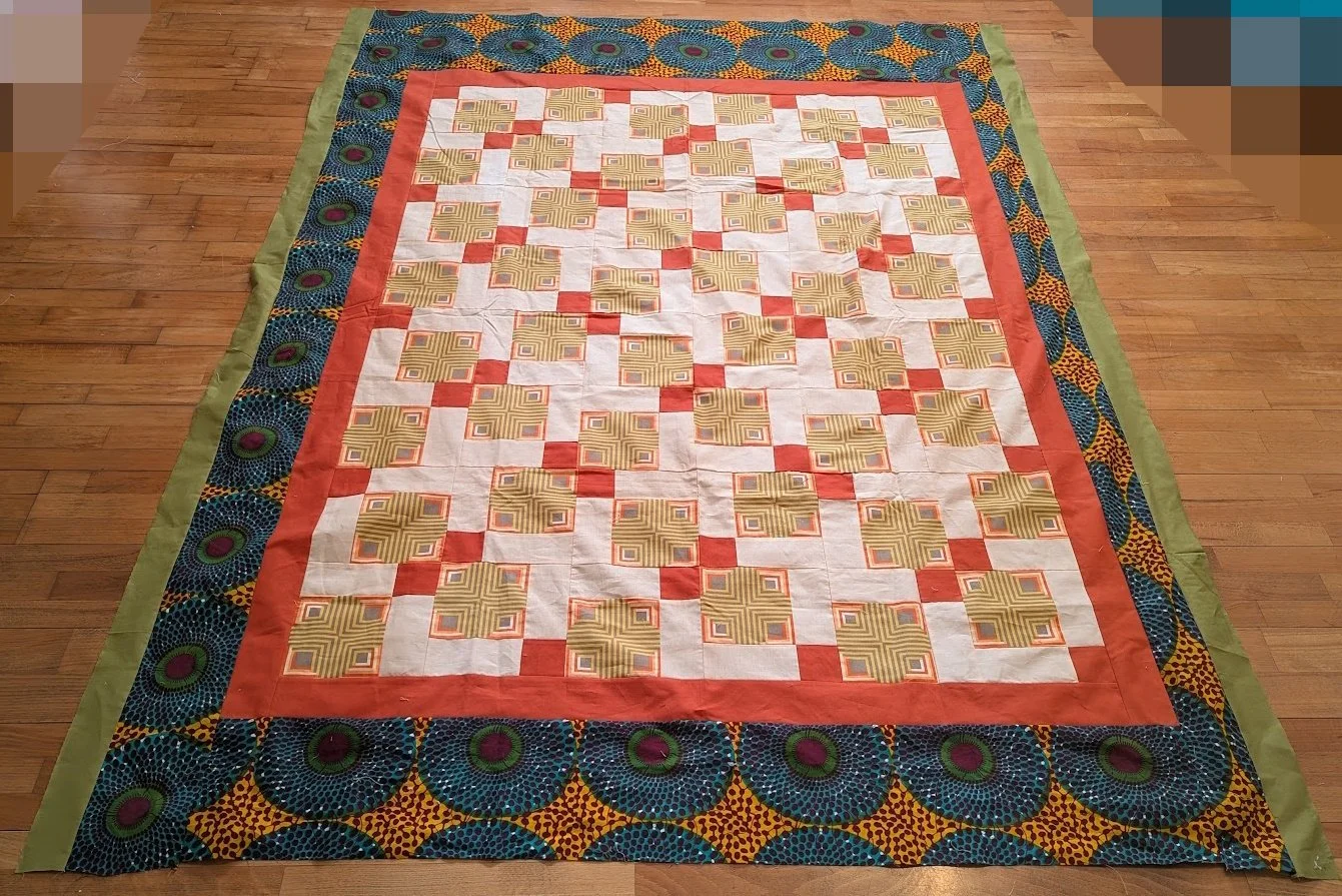 I added the green and batik and outer fabric to this amazing top donated by someone from the USA.