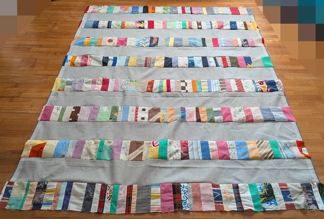 I used strips that Ewa's mom made which were rolled up and cut 6.5" strips x WOF from menswear I have and sewed them together to make this top.