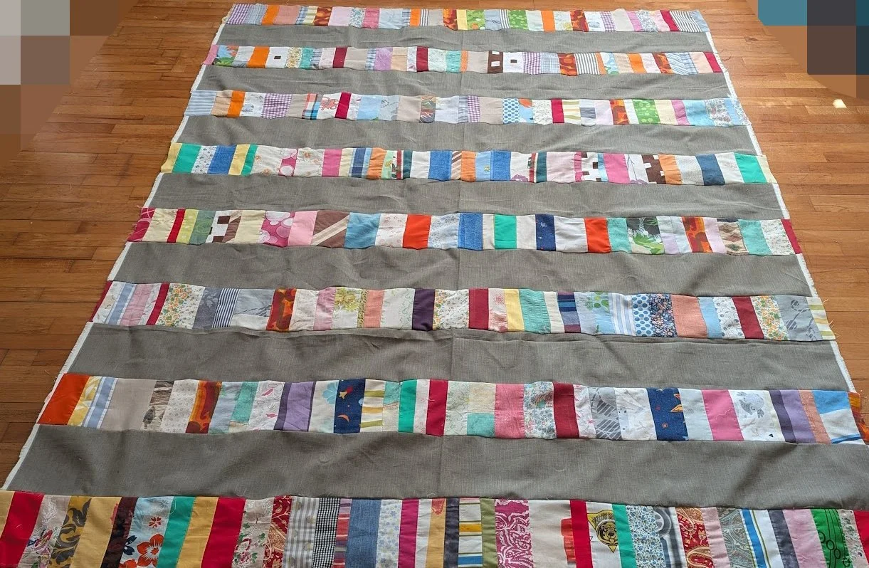 I used strips that Ewa's mom made which were rolled up and cut 6.5" strips x WOF from menswear I have and sewed them together to make this top.