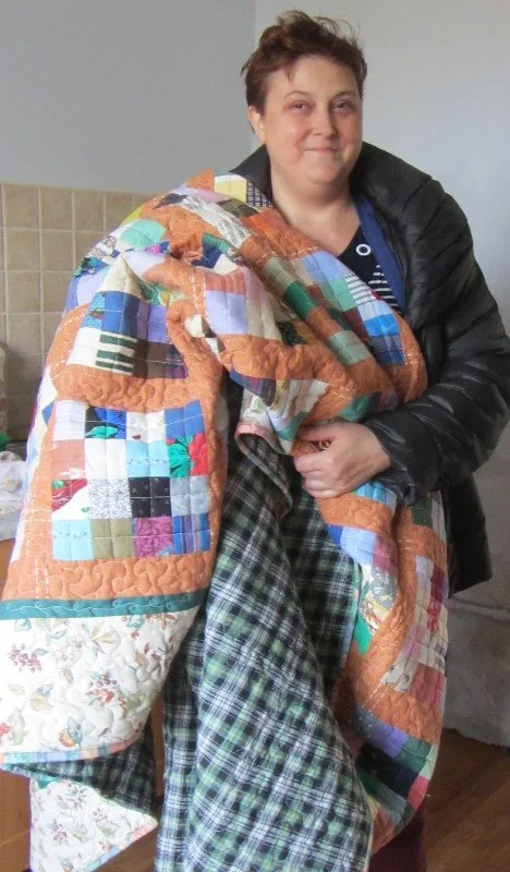 Kasia with charity quilt.JPG