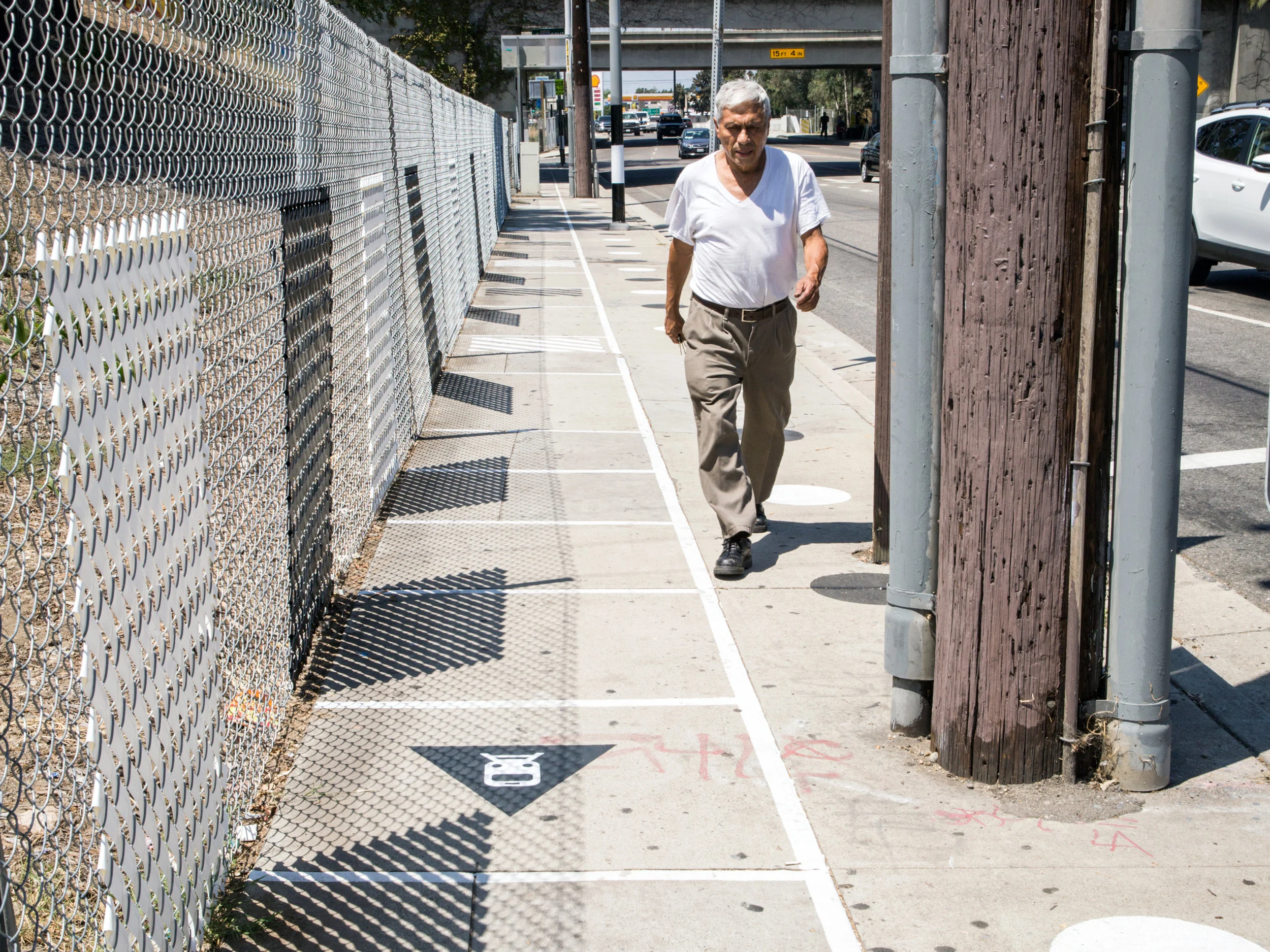 After: New Fencing, Sidewalk Patterning + Wayfinding, Fence Weaving, and Pole Wrappers