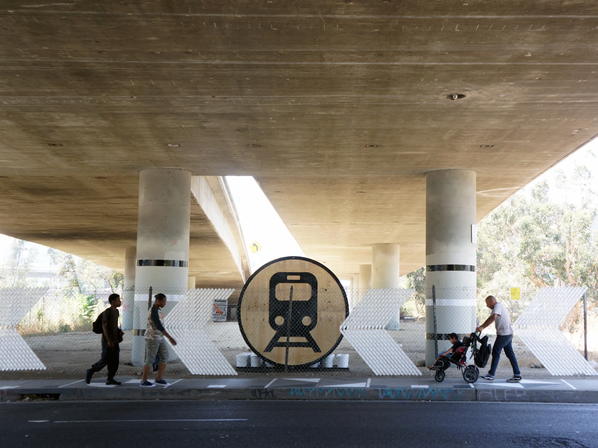 After: Wayfinding Signage, Column Wrappers, Sidewalk Patterning, New Fencing with Fence Weave