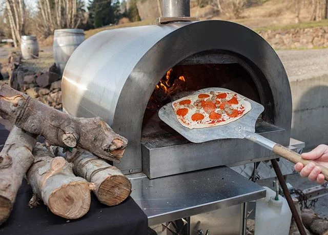 About to load up a meat lovers pizza in to one of our wood fired pizza ovens. The oven runs at about 900 degrees Fahrenheit so it&rsquo;ll be out in about two minutes. Yum!! 😋