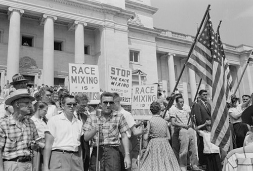 Hostile crowds protest the integration of schools in Topeka, KS (circa 1954)