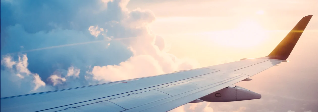 Edited photo of a plane wing among the clouds