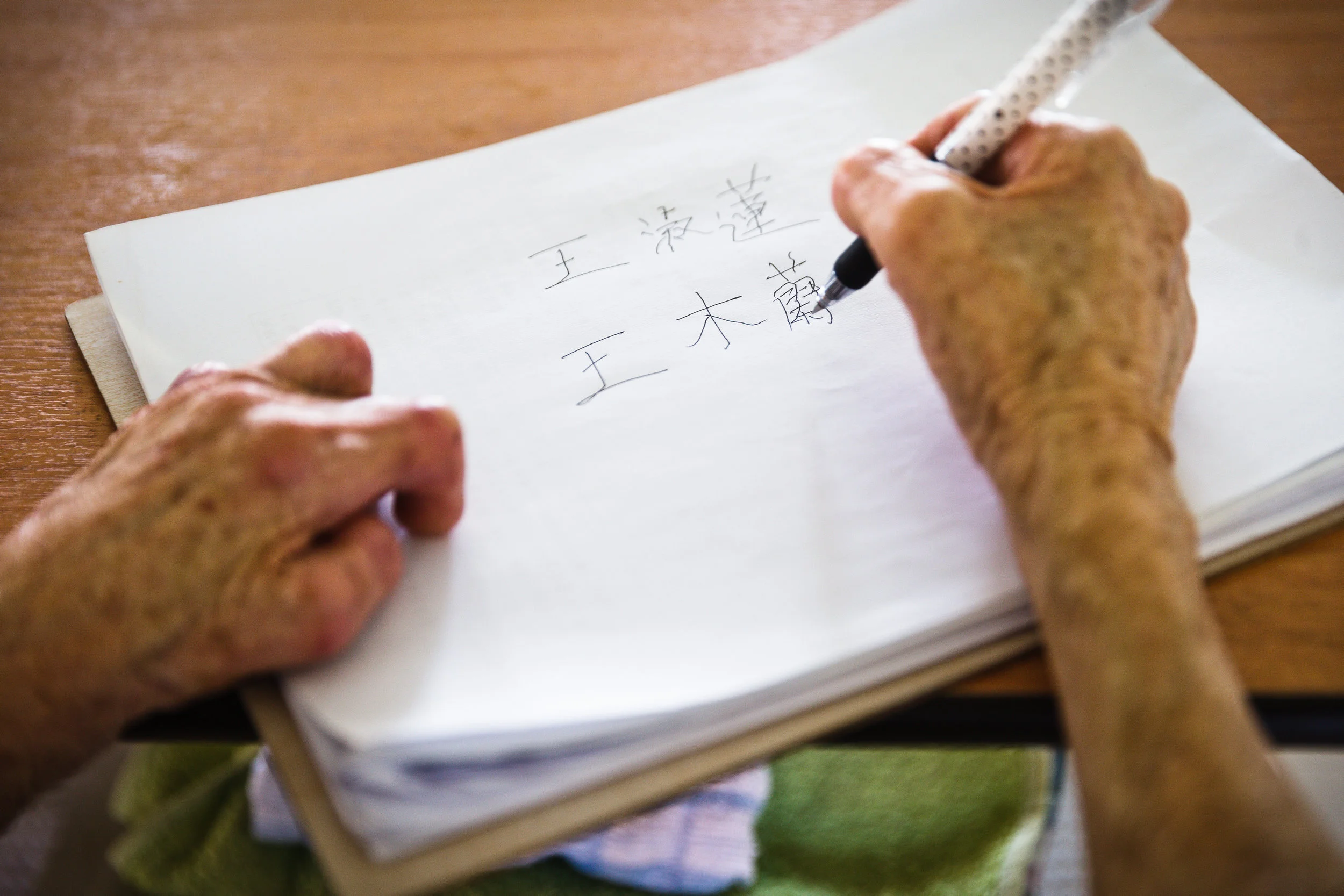 Heng wrote the two names that were given to her by her parents. (photo by Mango Loke)