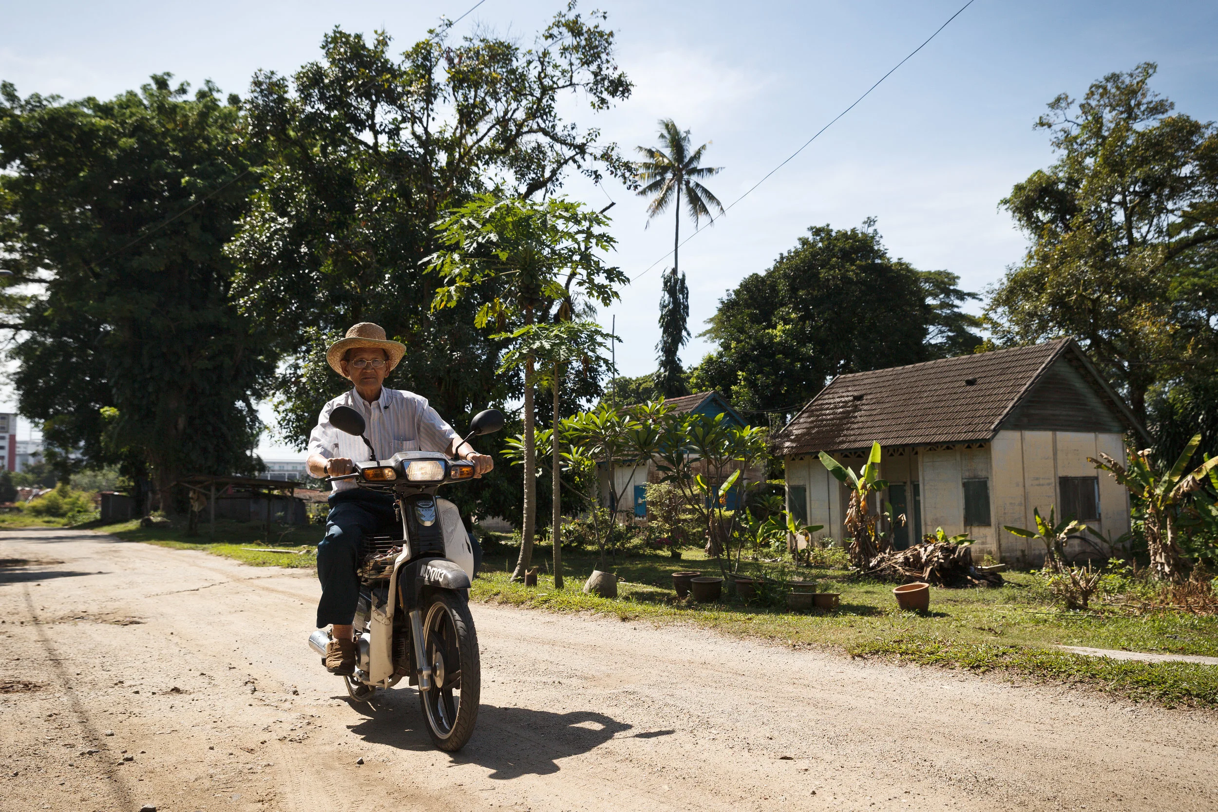 The motorbike is his only means of transport. (photo by Mango Loke)