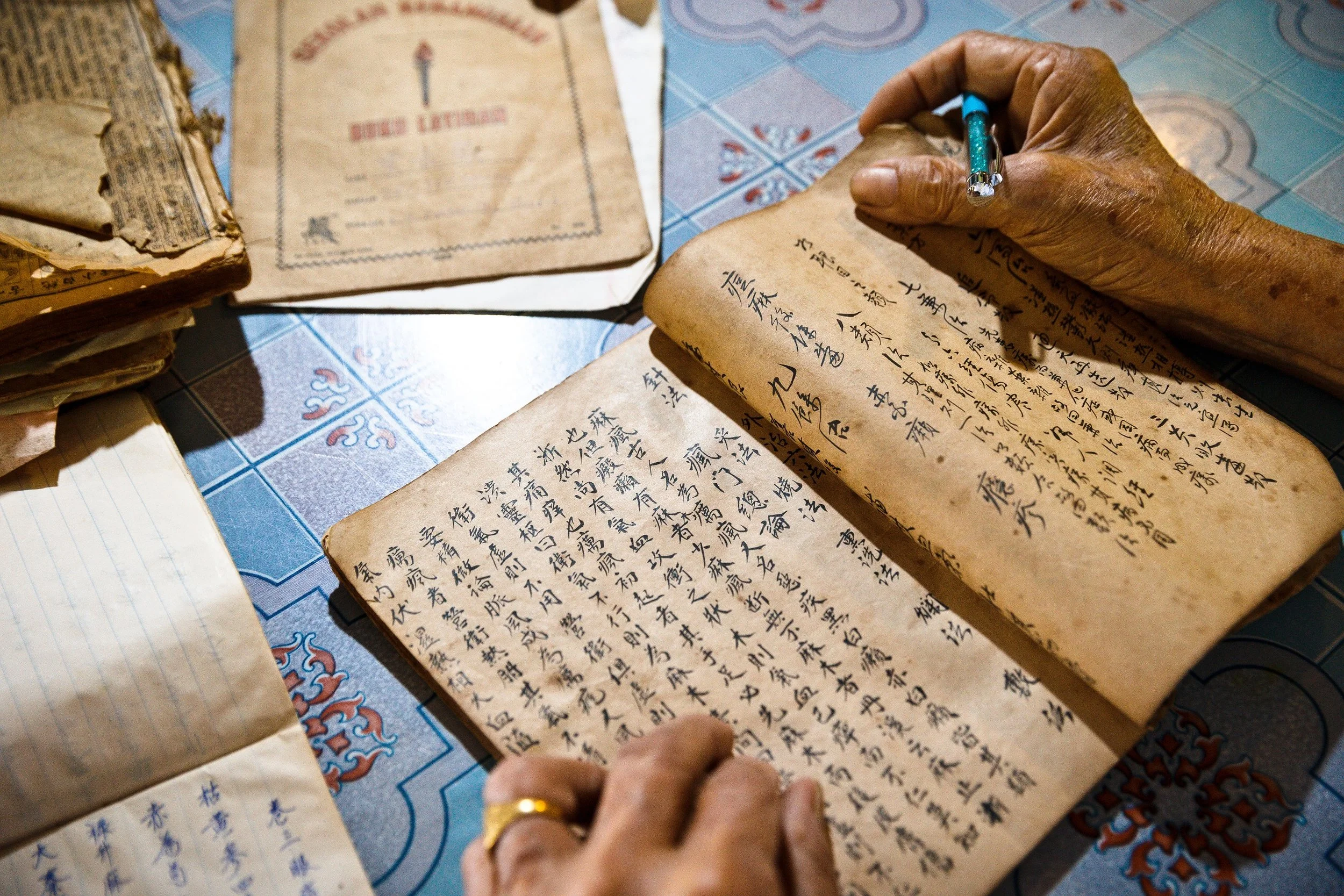 The Traditional Chinese Medicine book passed down from his ancestors. (photo by Mango Loke)