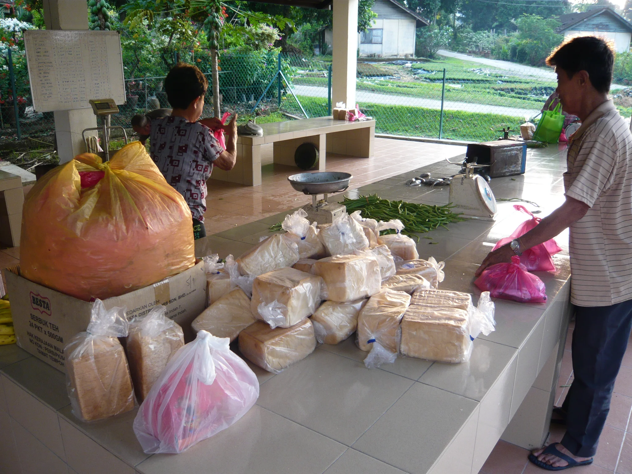 The section attendant allotting the rations for the residents living in the chalets. (photo by Joshua Wong )