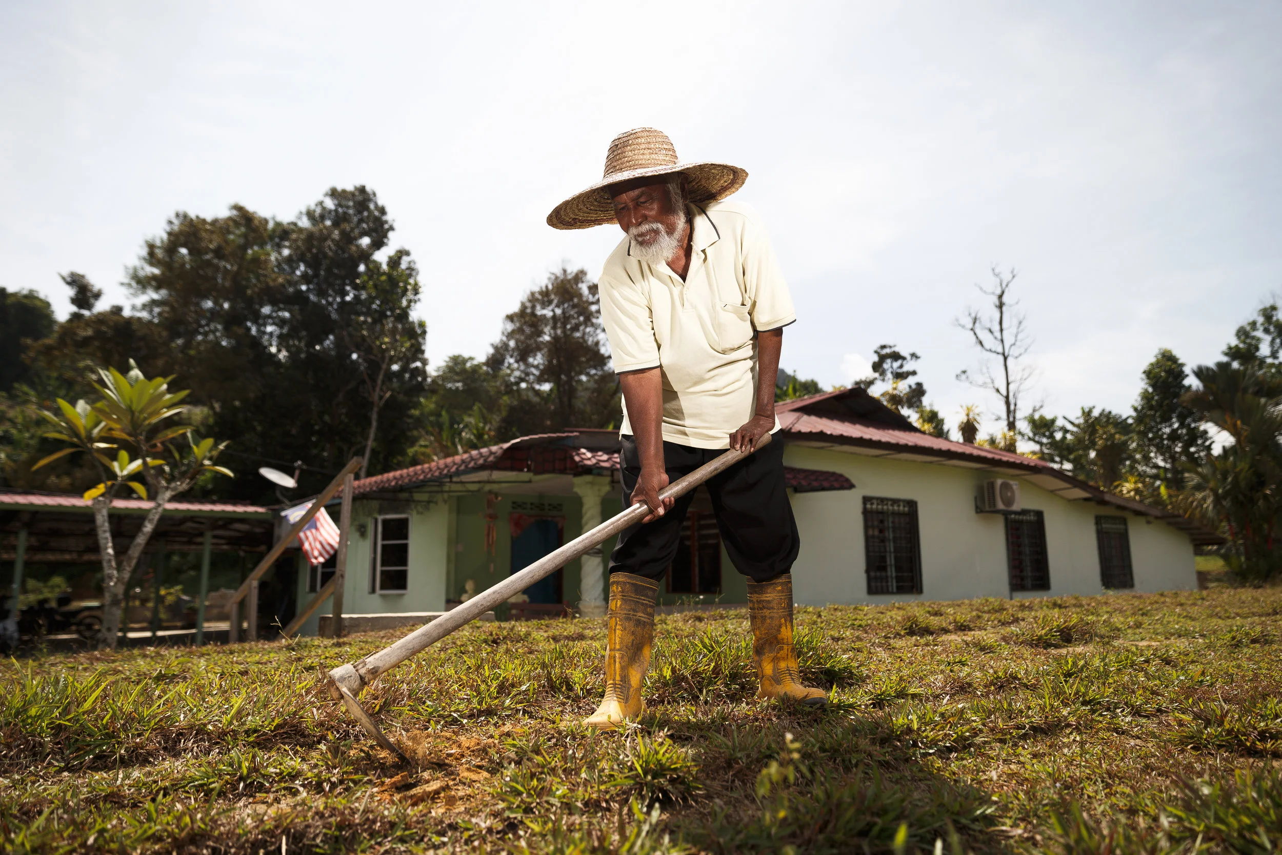 Haji Rauf, the only surviving lawn care worker in the settlement. (photo by Mango Loke)