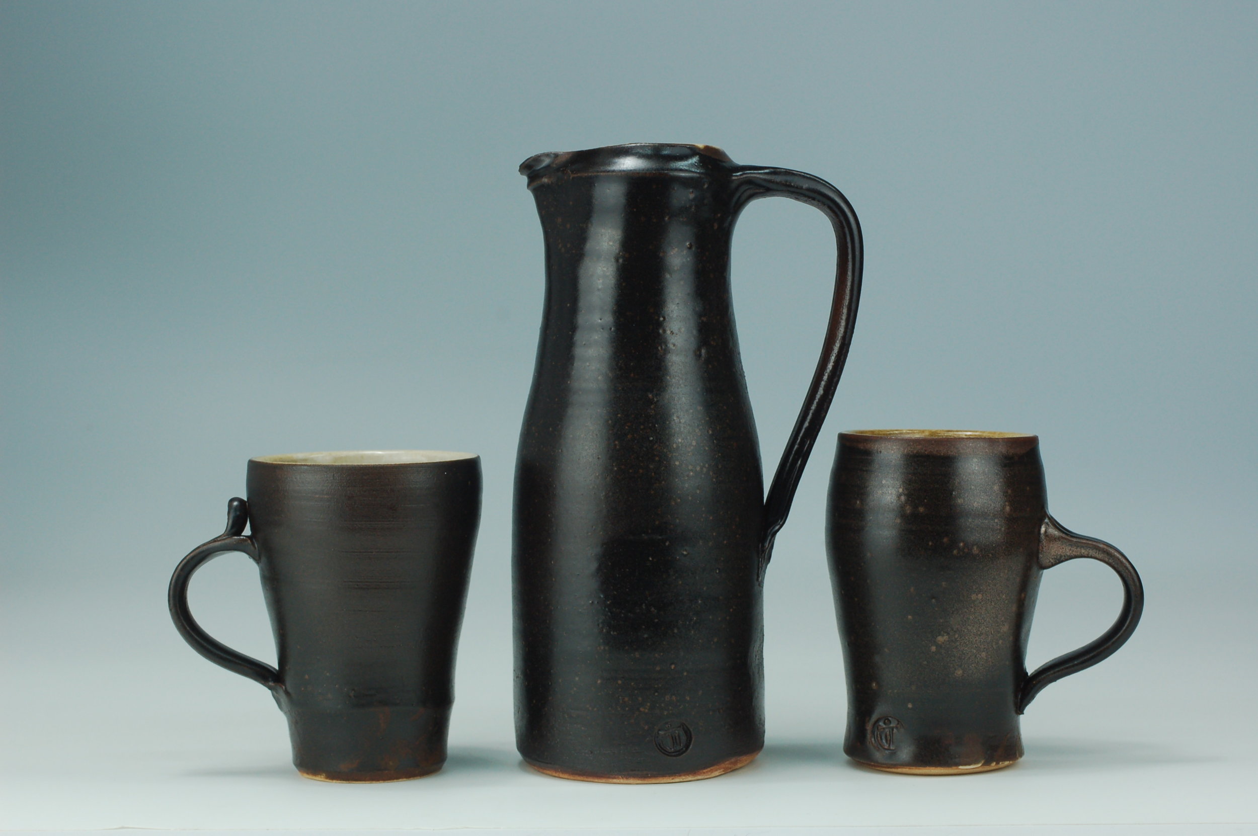 Pitcher in the style of Leach Pottery and mugs