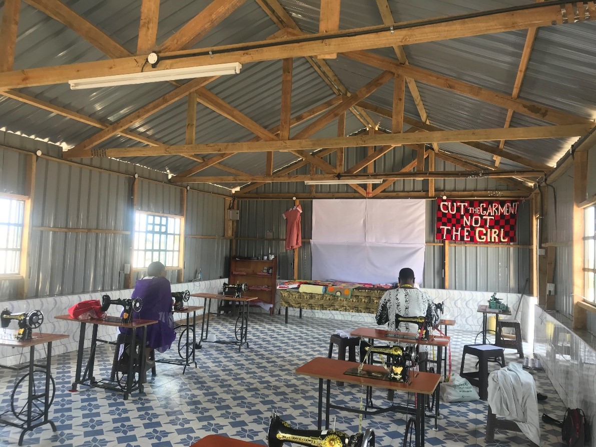 Women sew garments at a new community center. Garments will be taken to market.