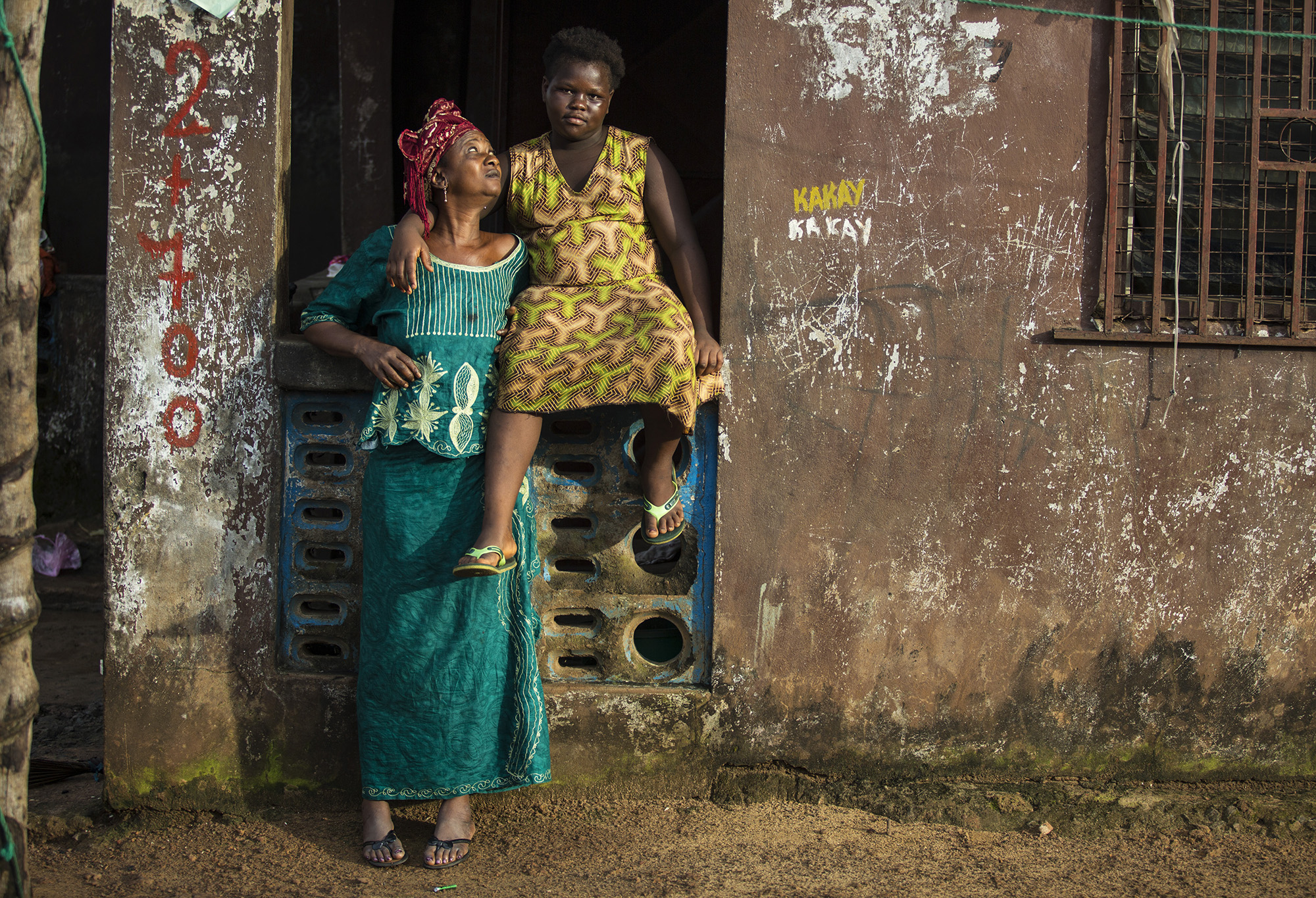 Isata Mansaray, Ebola survivor and orphan, with her grandmother Fatmata Mansaray, Sierra Leone. “When I was released from the treatment centre I was told that my parents had gone to America, but later my uncle admitted to me that they had died. When