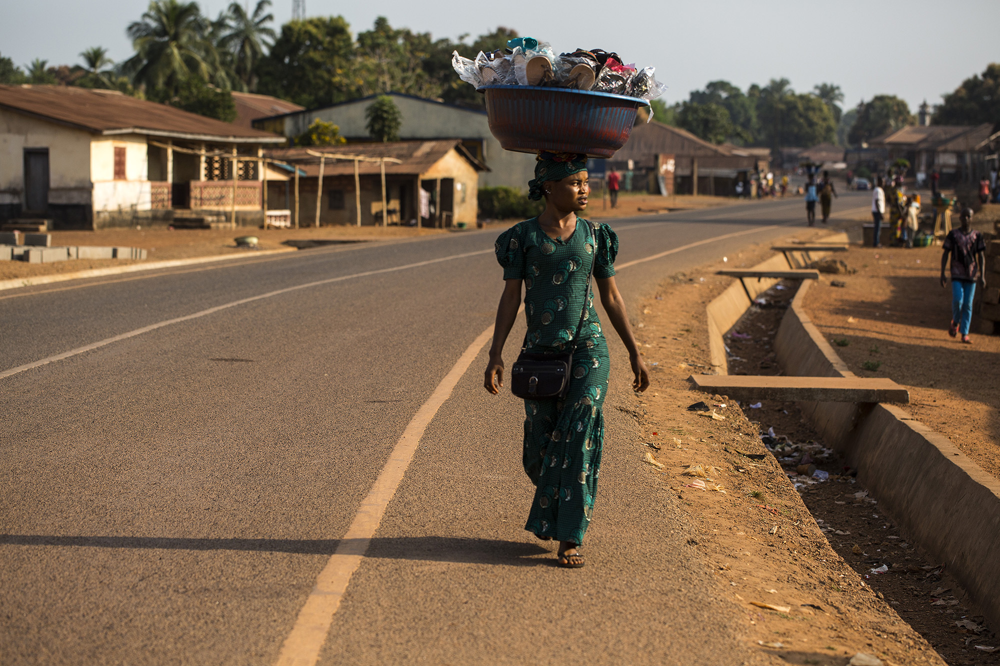 Mariatu Bangura, 18, of Rokupr, sells slippers to help provide for her son and herself. 