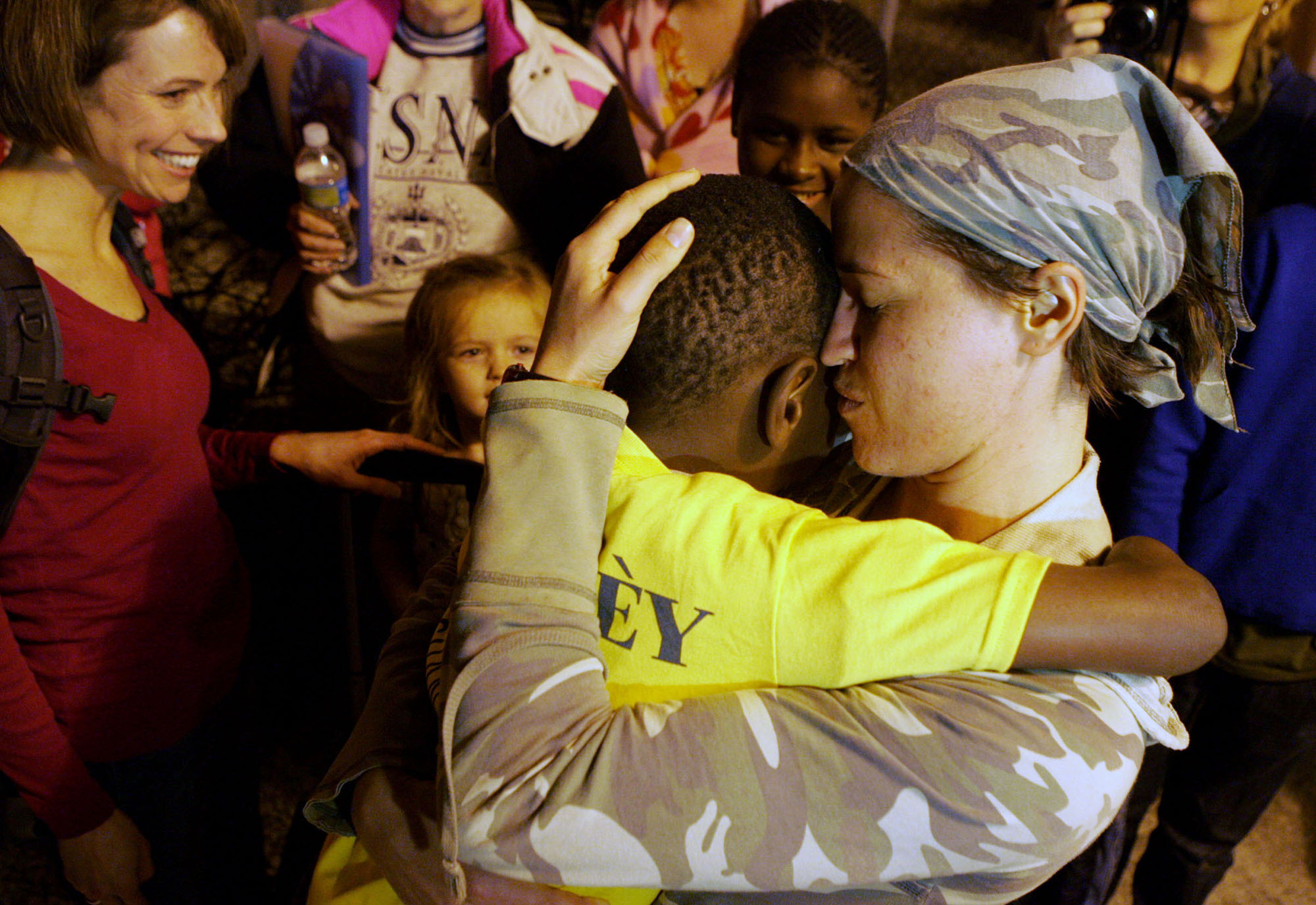  Abbey McArthur, a teacher at Three Angels Children's Orphanage in Petionville, Haiti hugs Reece Yunker, 8, a recently adopted orphan, after he comes out of customs at the St. Lucie County International Airport on Monday night. All 26 orphans from Th