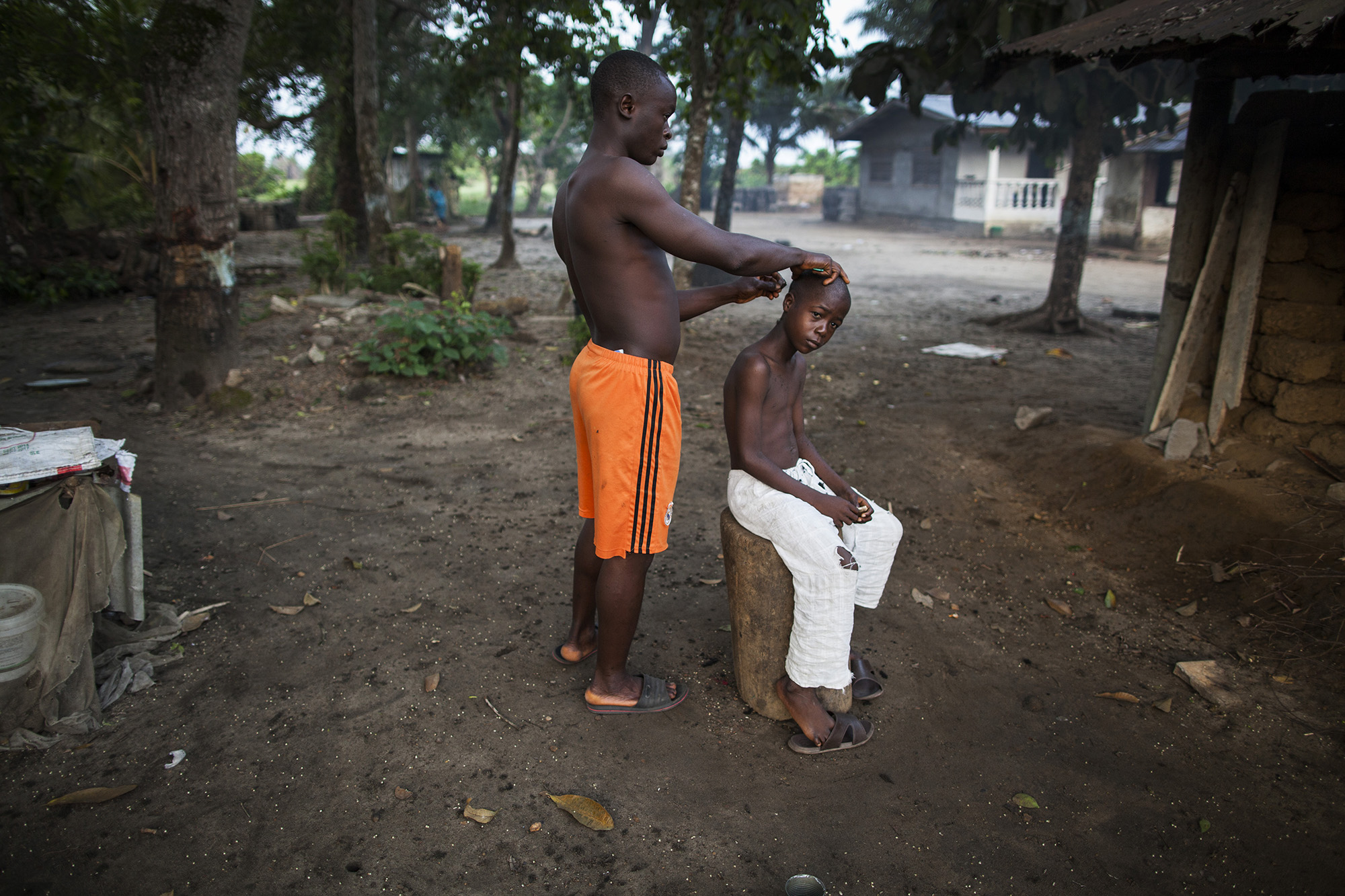  A boy receives a hair cut near his home in Brewersville, Liberia.&nbsp; 