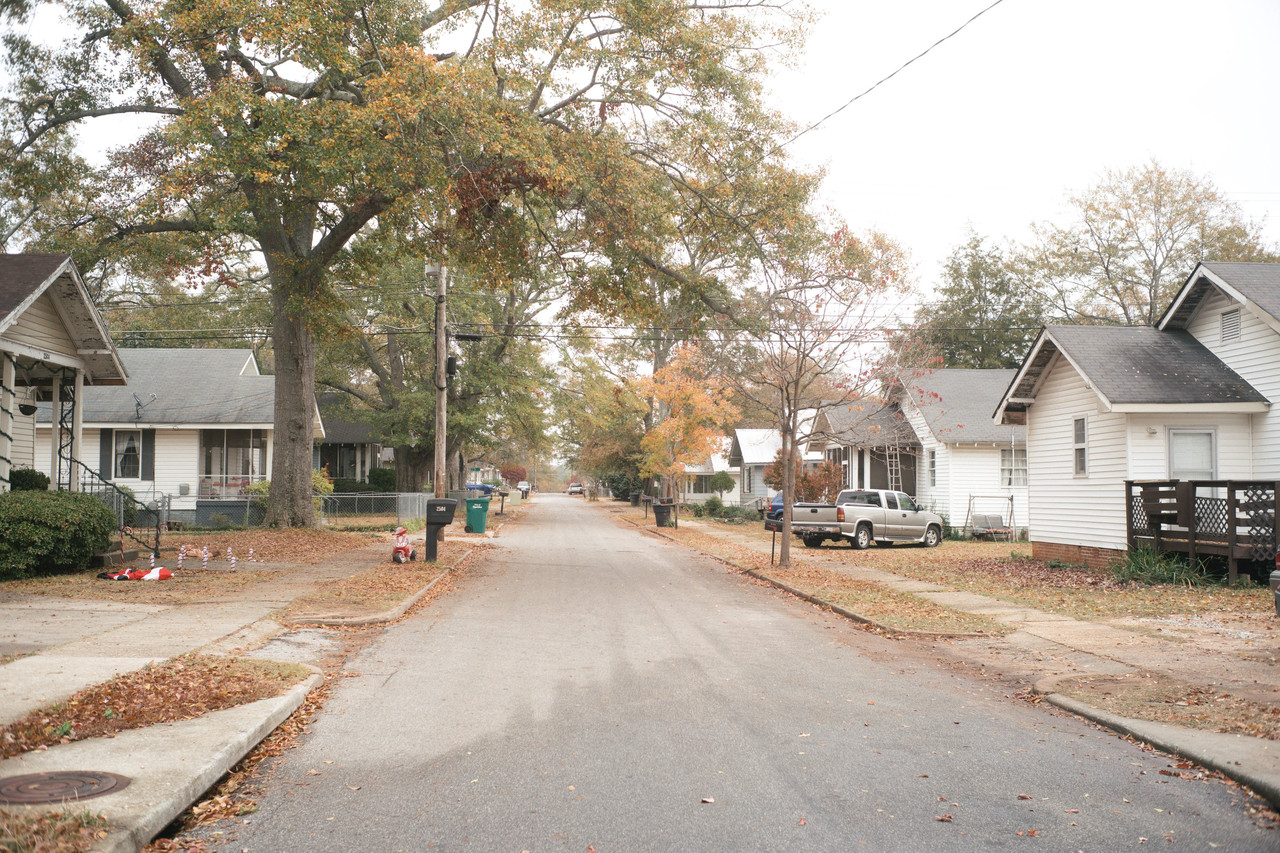 A burned-down textile factory and homes that were built for mill workers in Opelika, Ala. The city has bounced back from job losses caused by Chinese competition.