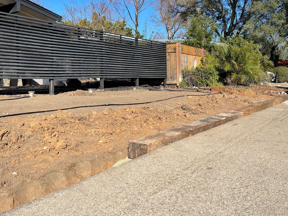  Railroad ties are placed a few inches below the sidewalk on a bed of pea gravel for leveling and drainage. 