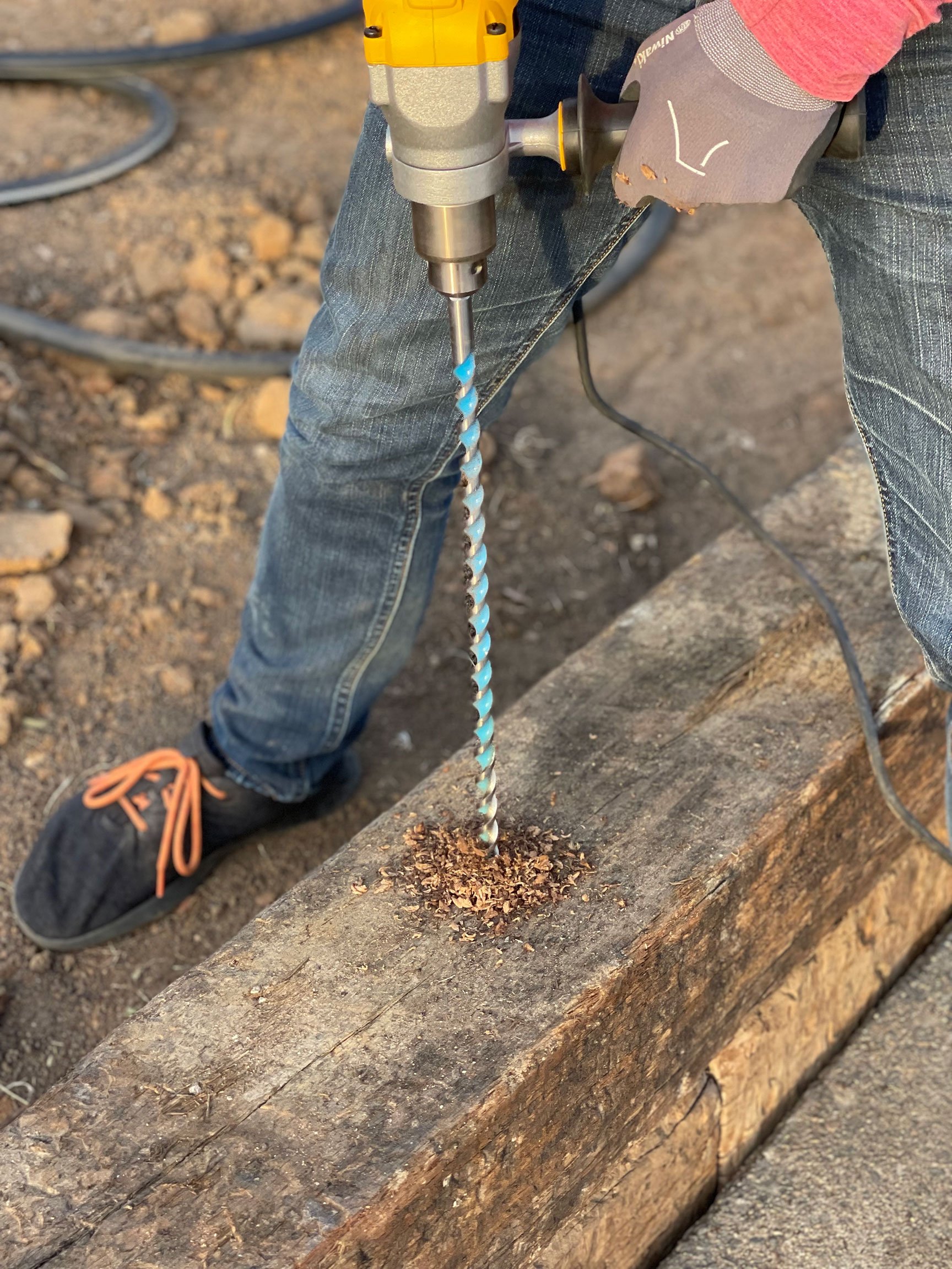  A 24” drill bit is used to bore holes for rebar stakes through both levels of the retaining wall. 