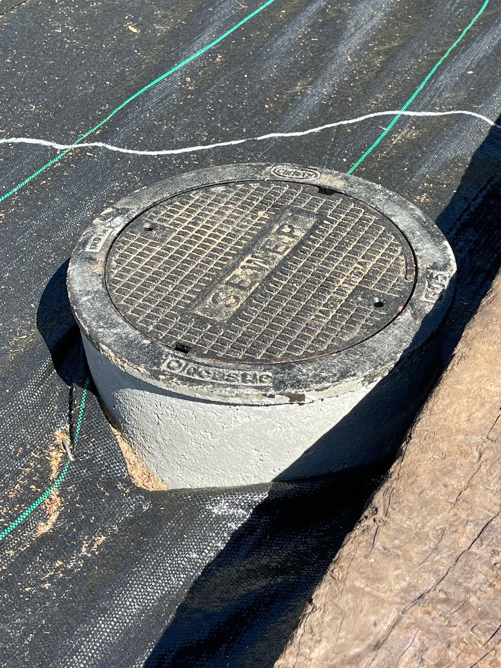 If you don’t like the look of a standard plastic sewer cleanout, contact your local sewer district to see about an upgrade like this concrete and cast iron model. It may be installed at little-to-no-cost to you. 