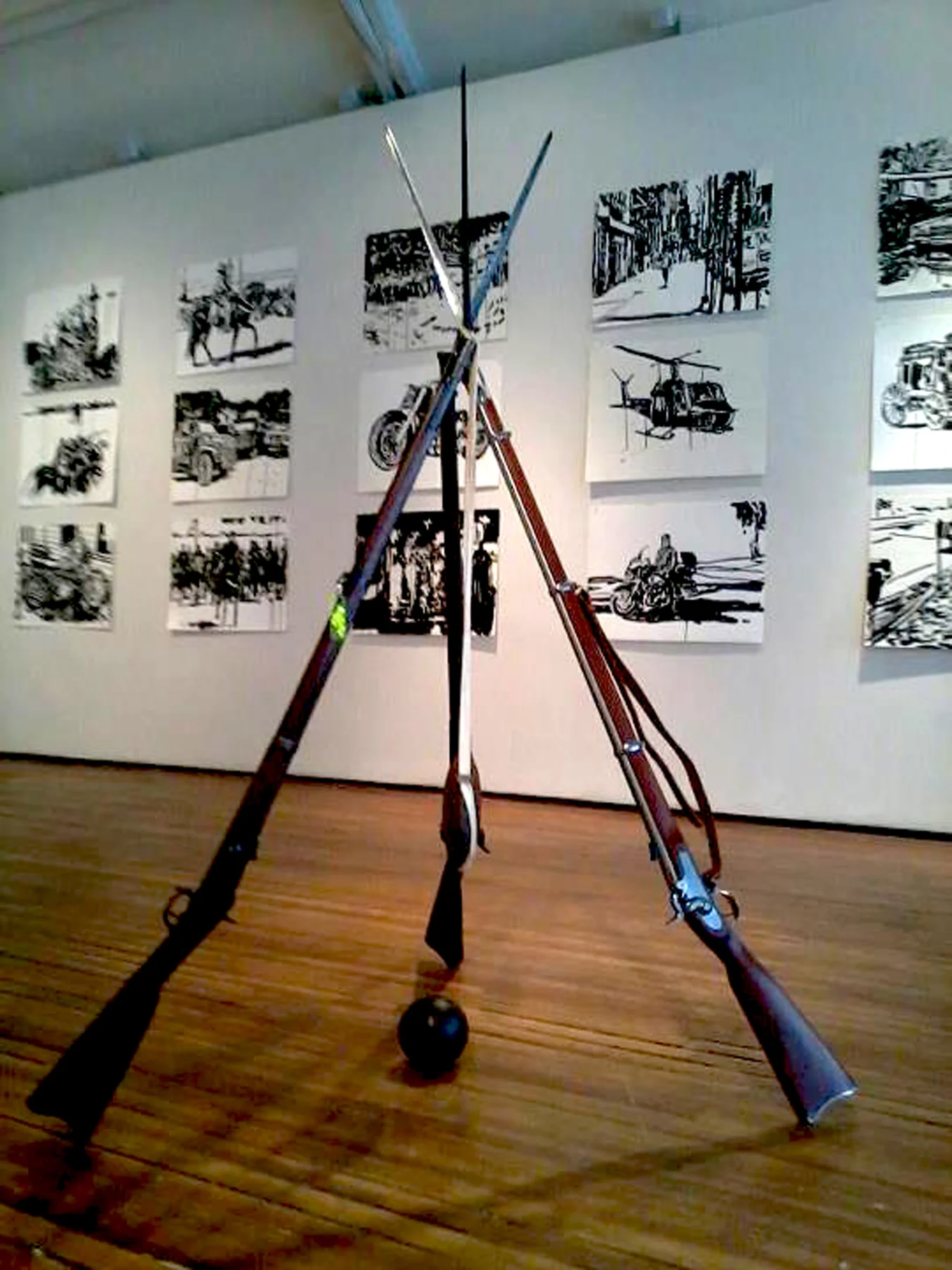 Stacked Muskets at Christopher Henry Gallery Show, "Exploding Sky". July 2014. Ink Drawings in background.
