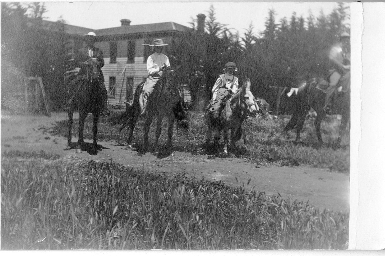 Riders behind the hotel, circa early 1900s.