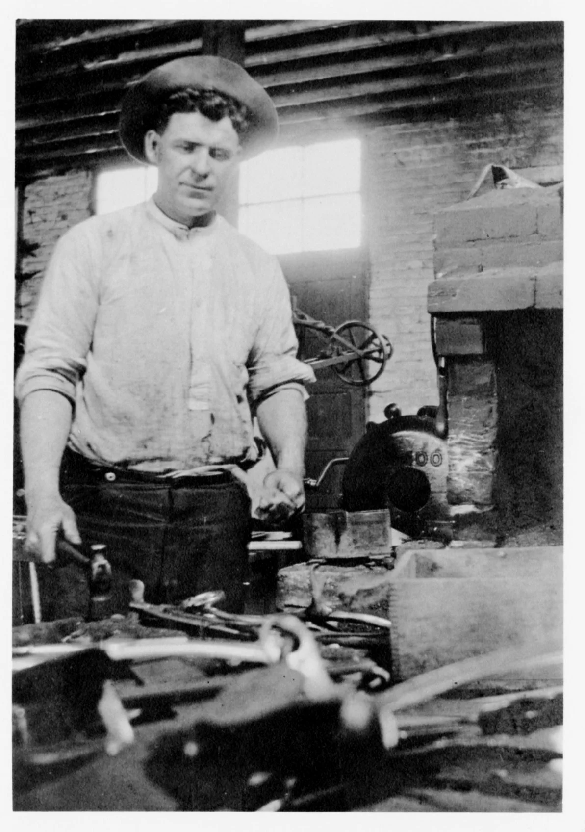 Fred Hunt in his blacksmith shop, 1915