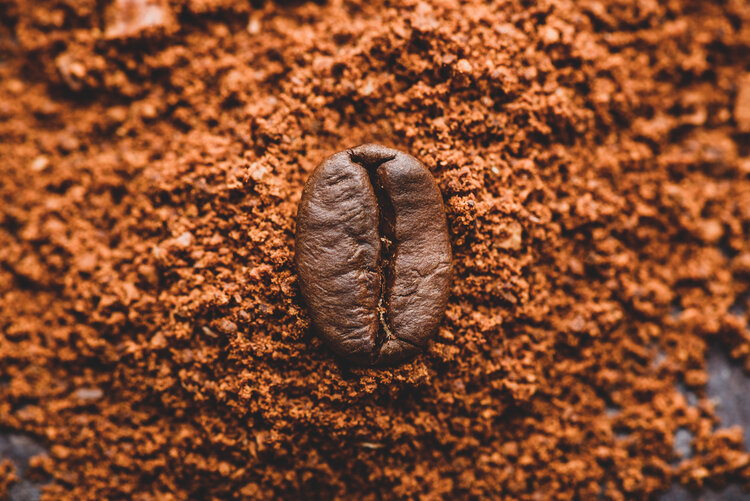 coffee-bean-on-heap-of-ground-coffee-RN2EHF3.jpg