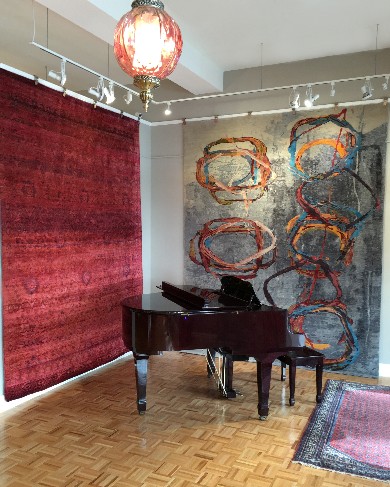 Art to Walk On appeals to affluent consumers on Florida's 'Gold Coast' with sophisticated designs from high-end brands, Zollanvari (left) and Wool and Silk Rugs (right) showcased in a gallery setting. 