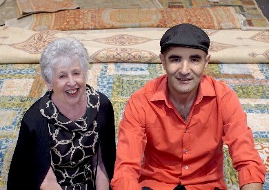 Eileen Hampshire, owner of Art to Walk On in Sarasota, Fla., takes a break with Wool & Silk's Erbil Tezcan during her shopping excursion to the Fall 2016 Rug Show at Javits.