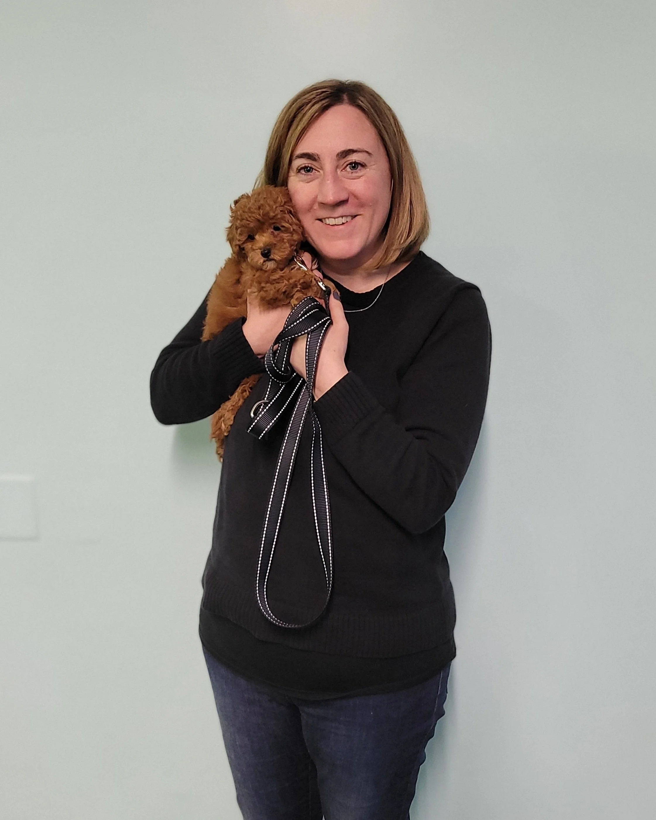 small brown puppy in training for separation anxiety and owner