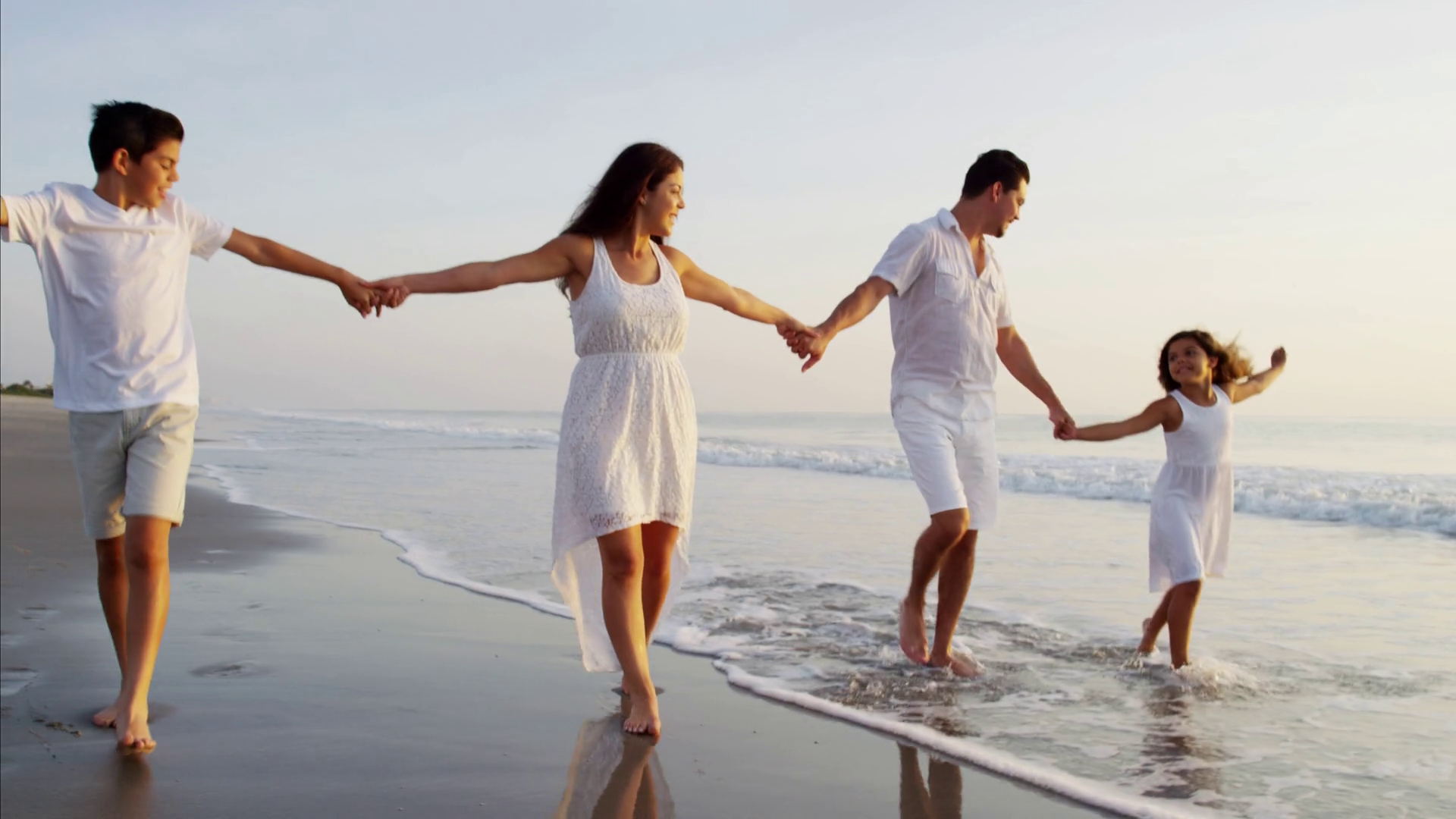 hispanic-parent-walking-with-children-on-the-beach-dressed-in-white-at-sunrise_sl2yz4mqx_thumbnail-full01.png