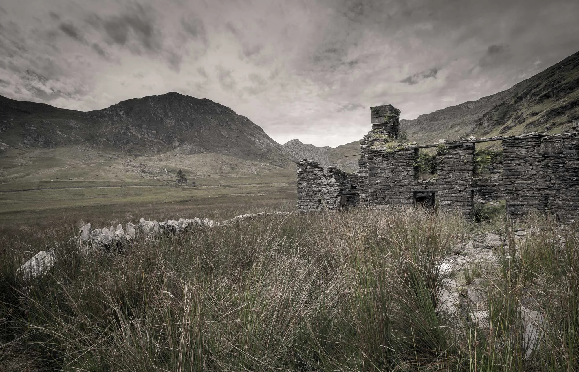 Ruined slate house with mountain