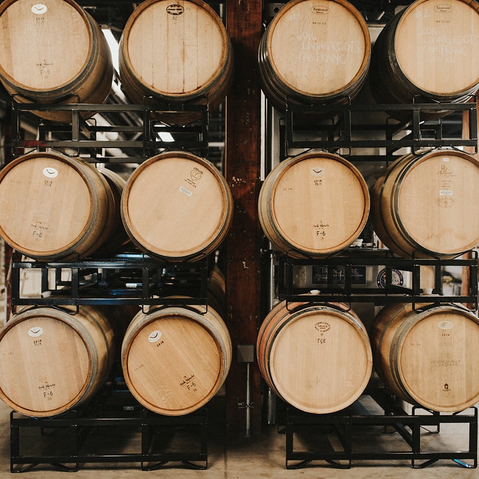 French barrels stacked up and full of Finger Lakes wine in the Living Roots urban winery in Rochester, New York.