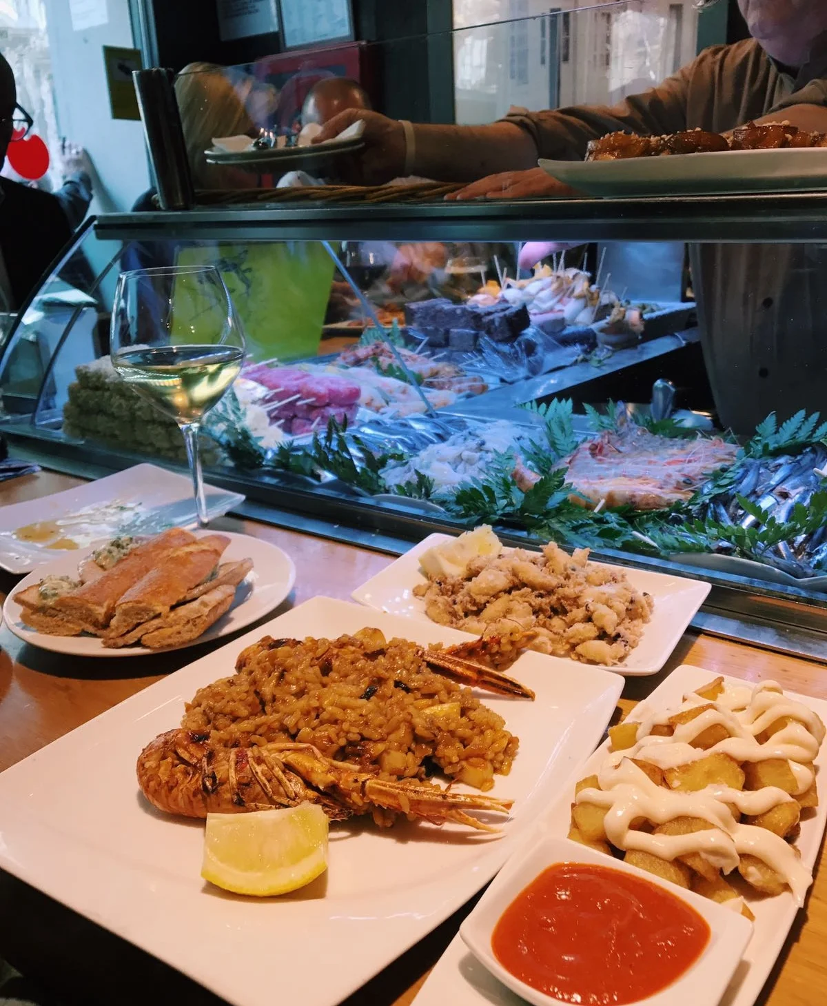 From left: Pork sandwich, Paella, Fried calamari, those addictive potatoes!