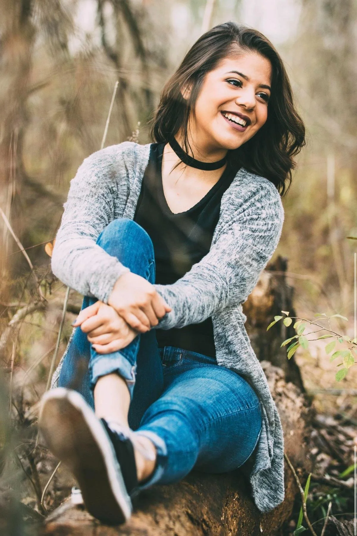Portrait of a woman in a grey cardigan smiling outdoors, Orkams collab series