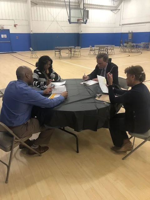 The panel of judges discussing the merits of each student presentation. L-R: Clinton Hamilton, COO; Jacqueline Roberson, Social Worker; Fred Wilms, Carver board member; ad Elsie Lopez, Executive Administrator