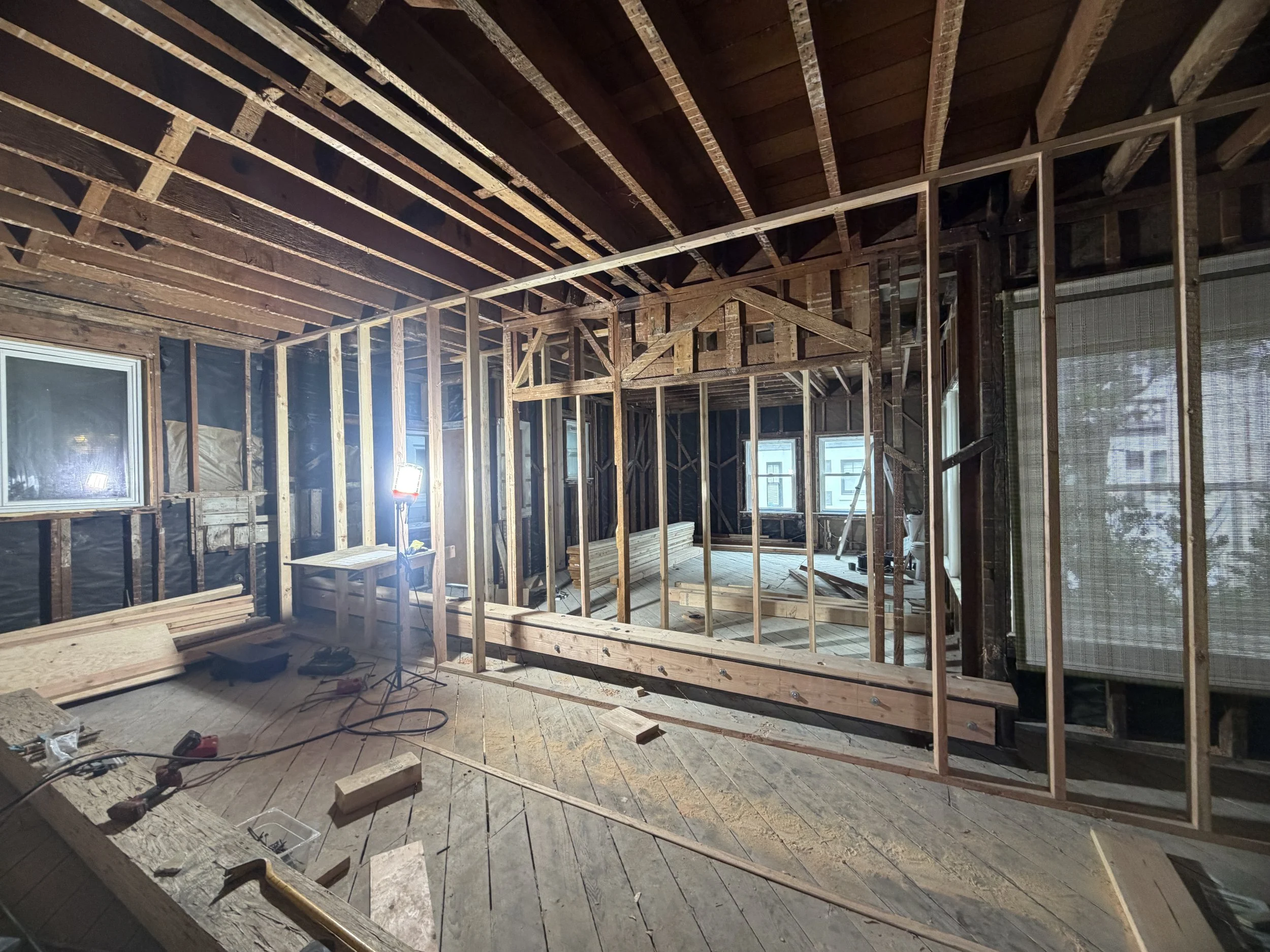 Existing structural walls have been removed to create our new open Kitchen & Dining layout. Temporary support walls have been installed to safely support the home while the new structural framing is being installed.