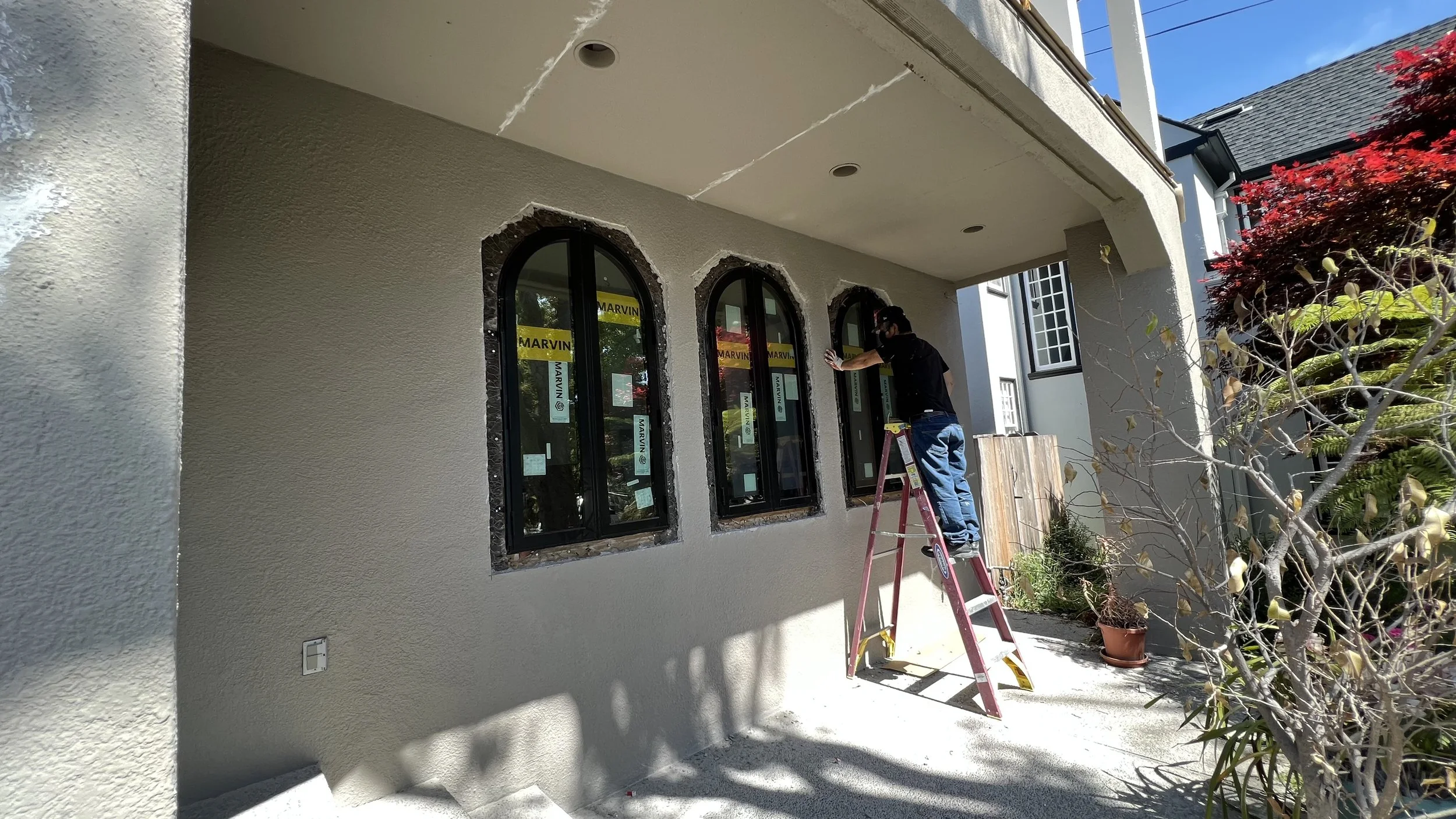  Chipping away the existing stucco to install the new round top french casement windows. 