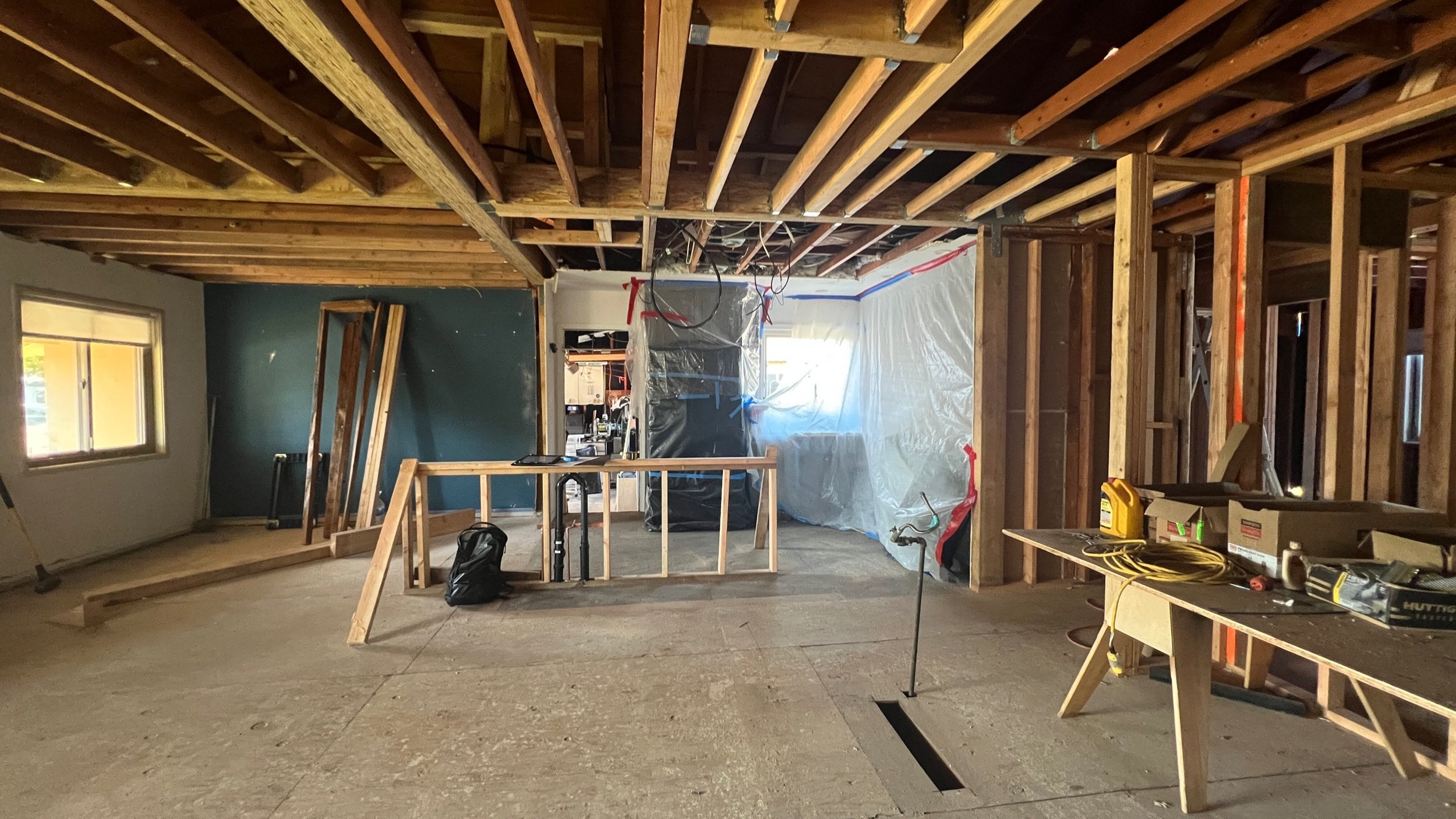 The new open Kitchen/Living/Dining/Coffee Bar is well underway with structural work complete. The island “pony wall” framing & plumbing are also in place.