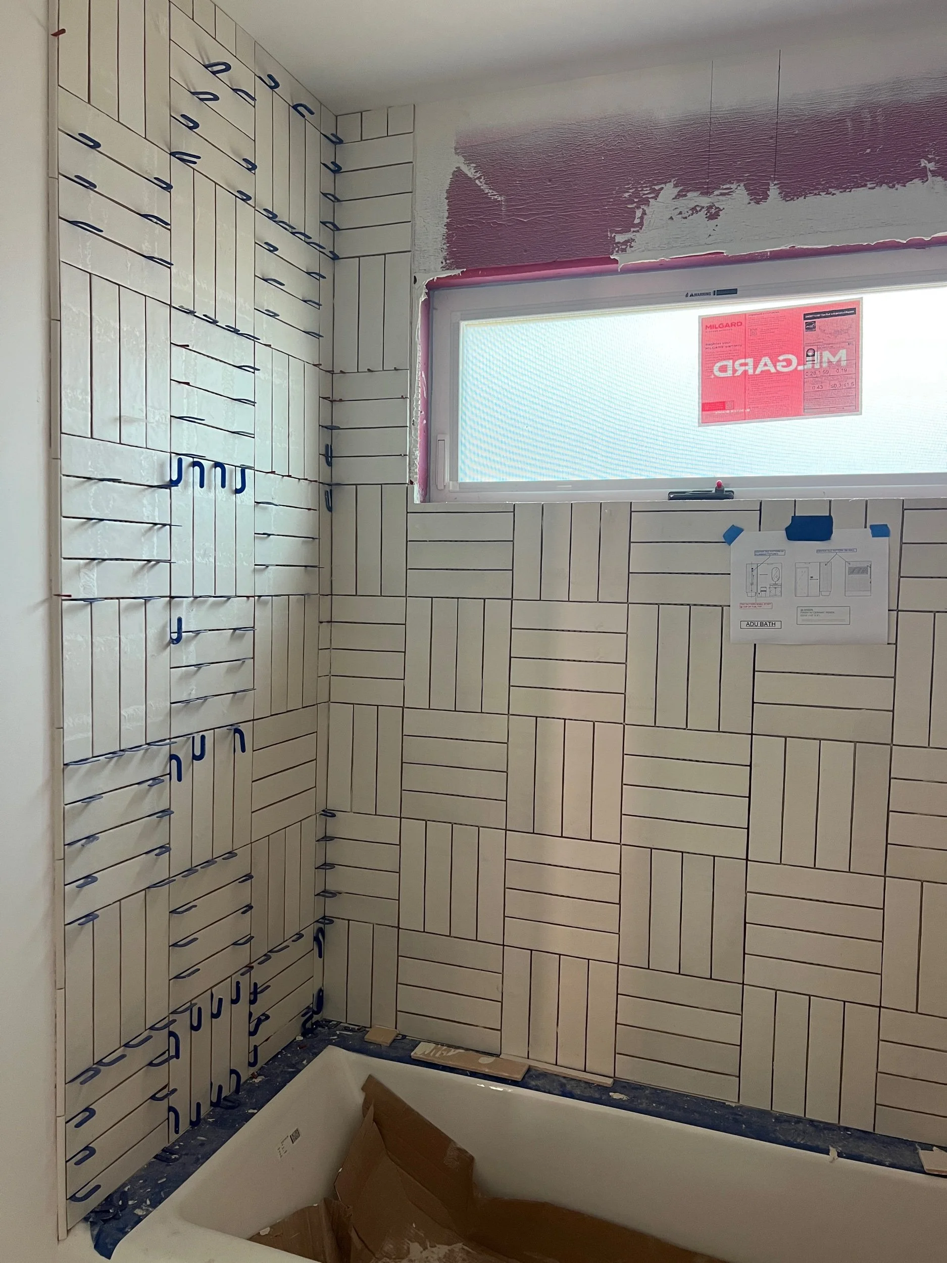 Seeing our ADU Bathroom come to life with our stacked basketweave tile pattern play.