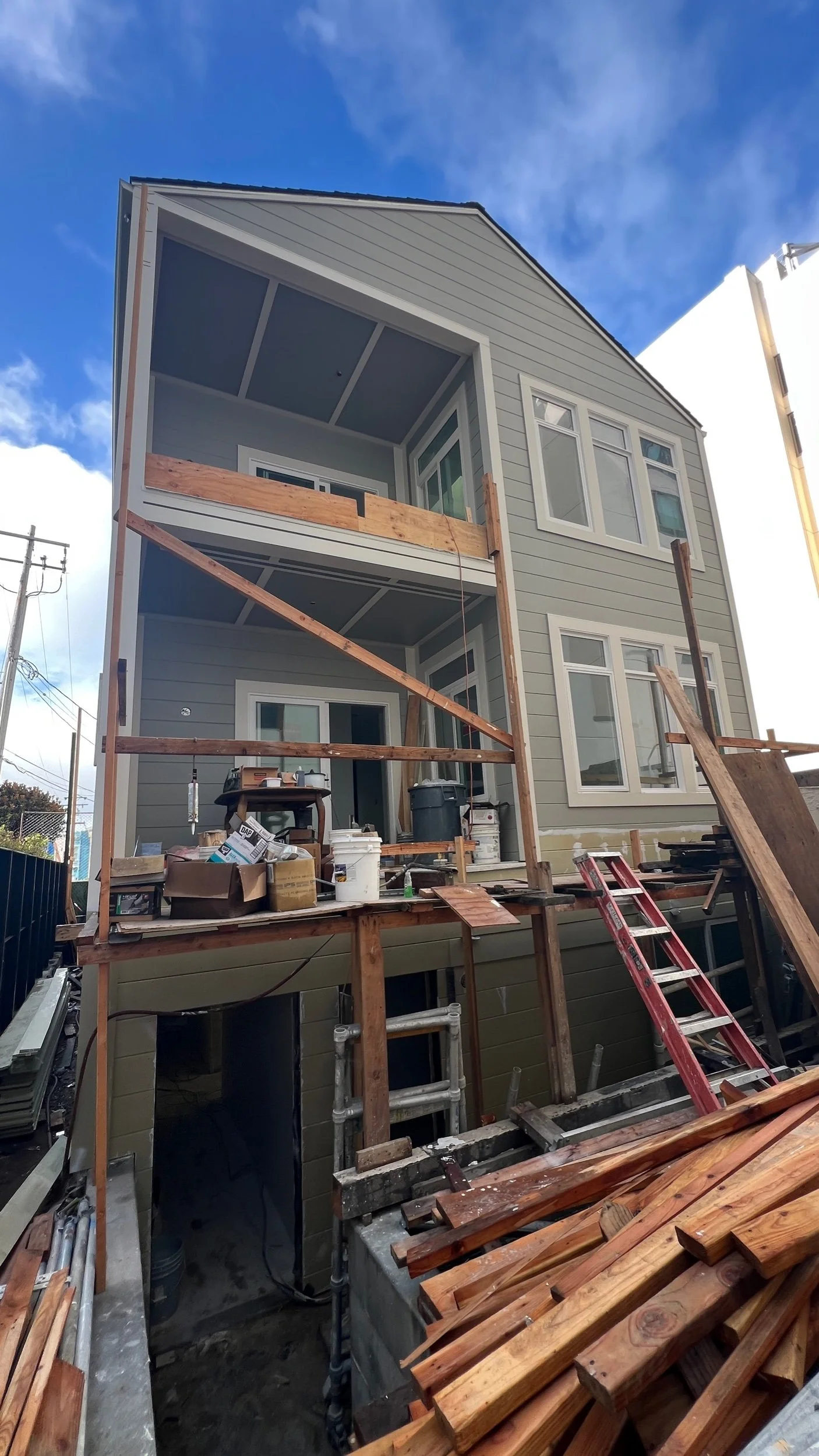 The rear addition is coming into view with new siding, windows, & trim up. 