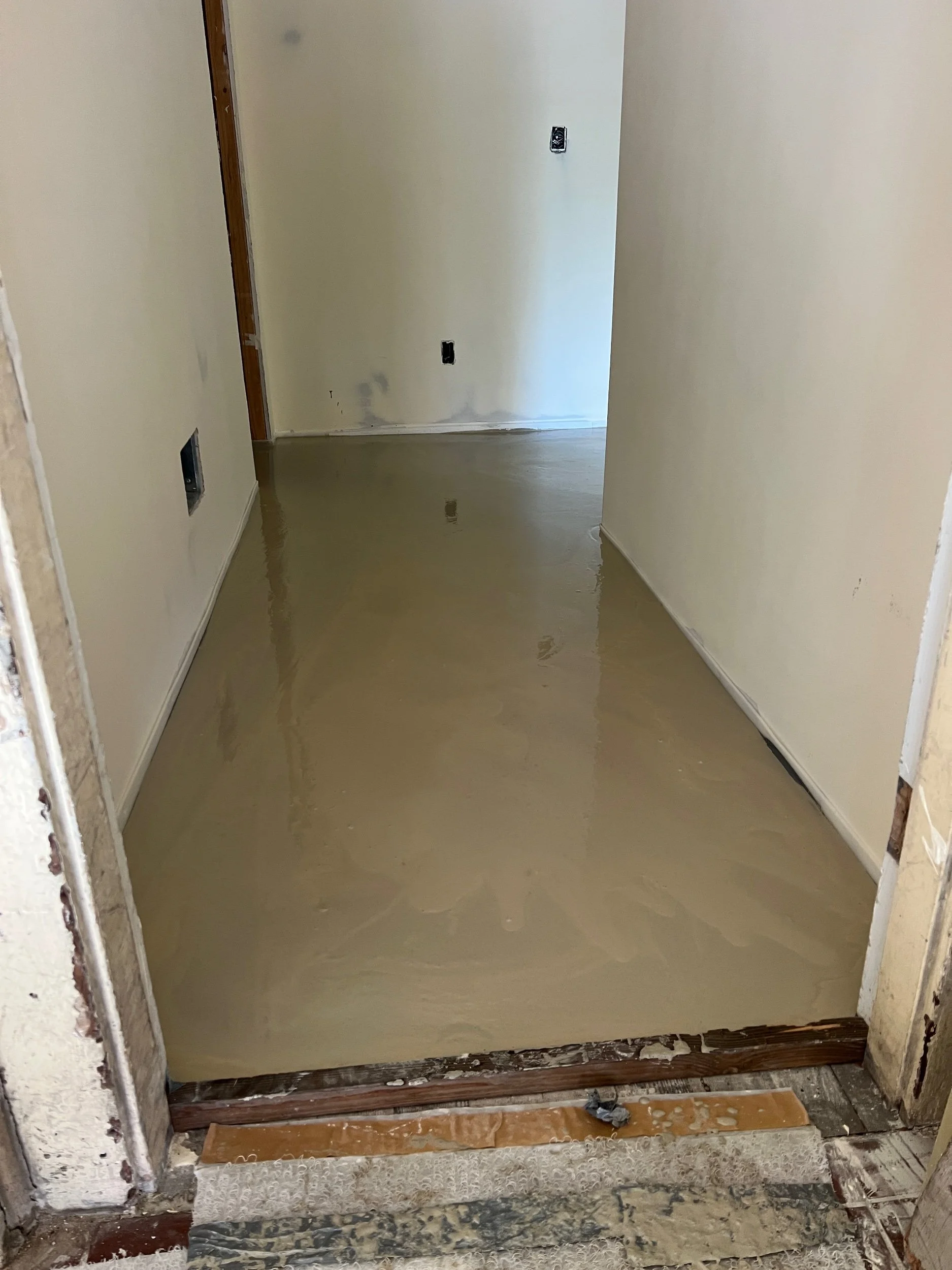 Gypcrete which is a lightweight gypsum-based concrete is being poured (over a 1/4-inch thick sound mat) between our units to improve fire ratings & reduce sound transmission.  Short break for the contractor as light foot traffic will be possible